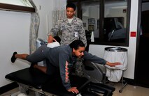 Airman 1st Class Daniel Franklin, 51st Security Forces Squadron entry controller, performs a quadruped with alternate extremity lifts for core strengthening during a physical therapy session Nov. 25, 2014, on Osan Air Base, Republic of Korea. The direct access clinic is held to provide treatment for service members who have had an acute musculoskeletal injury within seven-days prior to the visit. (U.S. Air Force photo by Senior Airman David Owsianka)