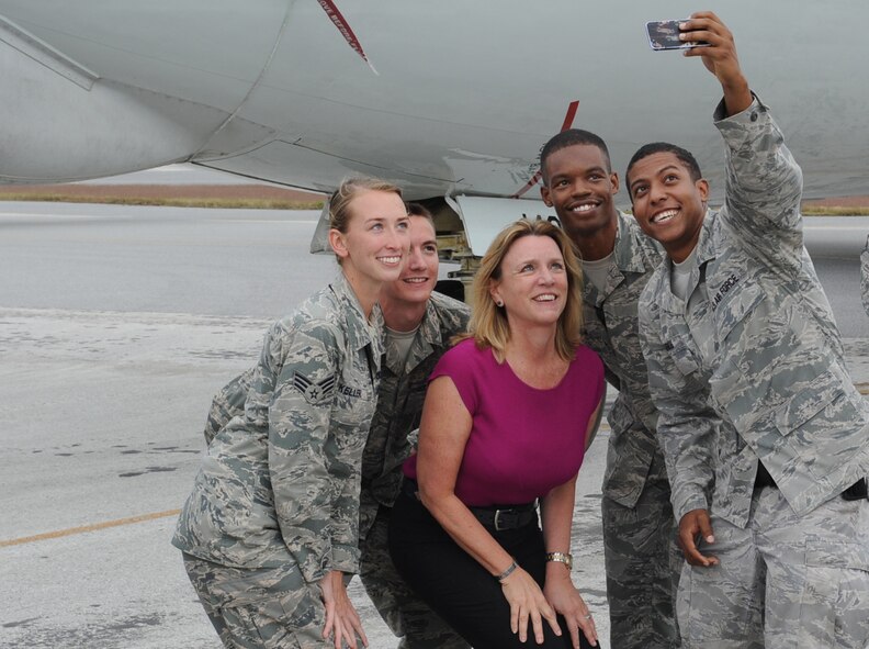 Secretary of the Air Force Deborah Lee James poses for a selfie with a small group of Airmen during her visit to Kadena Air Base, Okinawa, Japan, Nov. 25, 2014. James visited Kadena to get a firsthand look at Airmen in action across the Pacific with stops in Alaska, Guam, Hawaii, Japan and the Republic of Korea. (U.S. Air Force photo by Airman 1st Class Zackary A. Henry/Released)