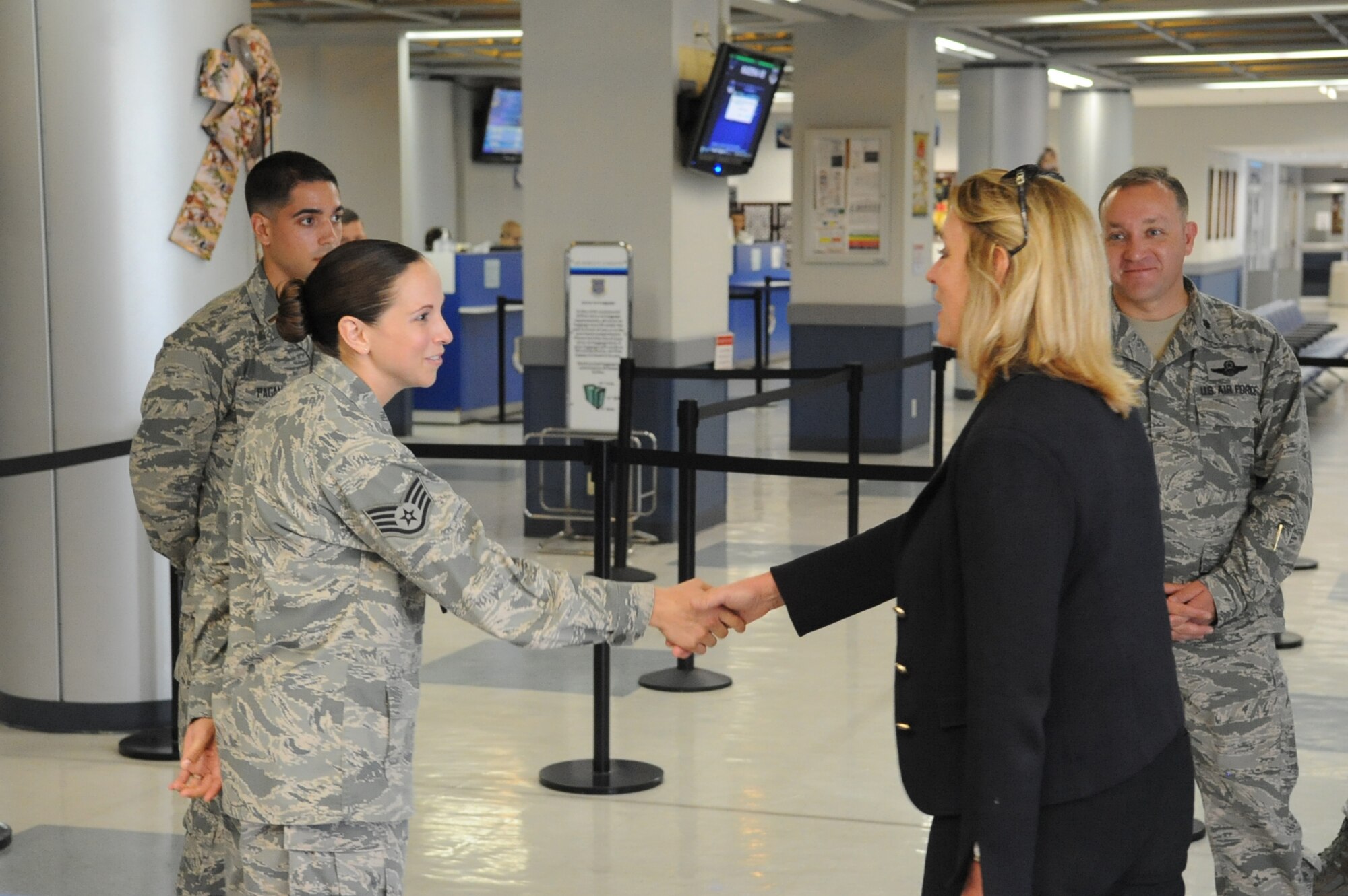 U.S. Air Force Staff Sgt. Brianna McNab, 733rd Air Mobility Squadron passenger service supervisor, shakes hands with Secretary of the Air Force Deborah Lee James during her Kadena Air Base visit, Okinawa, Japan, Nov. 25, 2014. James visited Kadena to get a firsthand look at Airmen in action across the Pacific with stops in Alaska, Guam, Hawaii, Japan and the Republic of Korea. (U.S. Air Force photo by Airman 1st Class Zackary A. Henry/Released)
