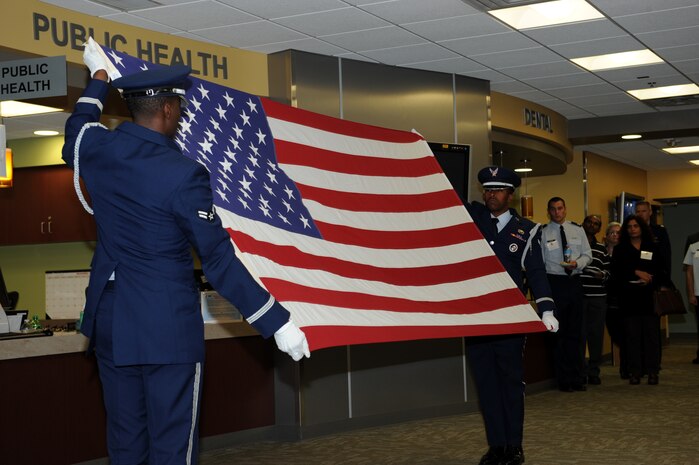 The Beale Air Force Base Honor Guard display a flag folding demonstration during an open house hosted by the 9th Medical Group at Beale Air Force Base, Calif., Nov. 20, 2014. The open house gave the clinic staff an opportunity to strengthen their medical relationship with local healthcare providers. (U.S. Air Force photo by Airman 1st Class Ramon A. Adelan/Released)