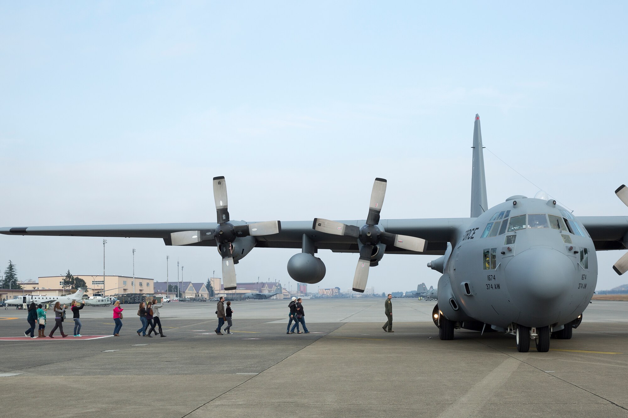Spouses from the 374th Operations Group and 374th Maintenance Group prepare to board a C-130 Hercules during Operation VOLANT SPOUSE 14’ at Yokota Air Base, Japan, Nov. 24, 2014. The 374 OG hosted an orientation flight to show their appreciation for their spouses. 