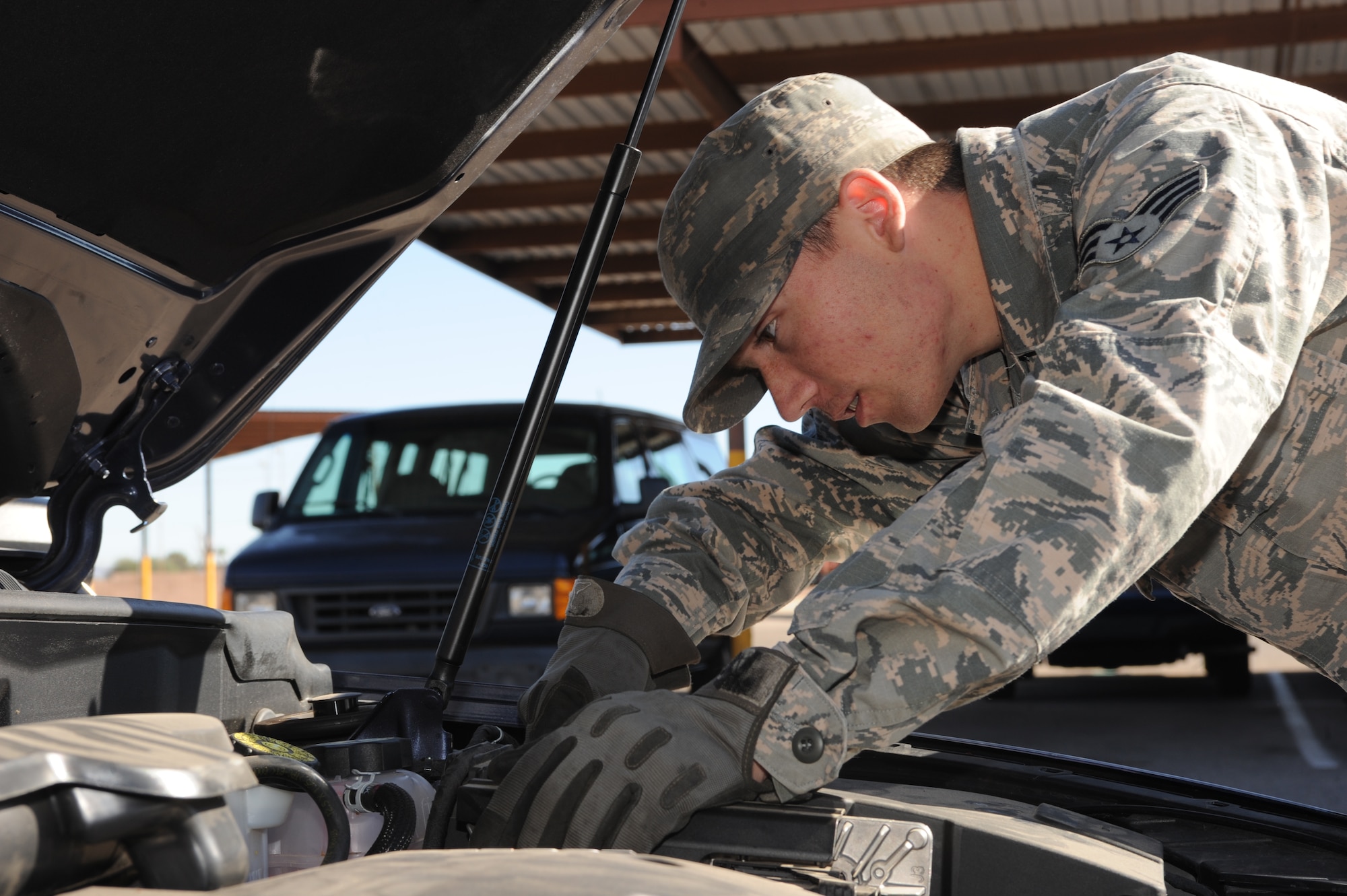 U.S. Air Force Senior Airman Andrew Liszewski, 355th Logistics Readiness Squadron vehicle operator and dispatcher, checks the fluid levels on a government-owned vehicle at Davis-Monthan Air Force Base, Ariz.,Nov. 18, 2014. Frequent fluid checks aid in the reliability of the vehicle. (U.S. Air Force photo by Airman 1st Class Cheyenne Morigeau/ Released)
