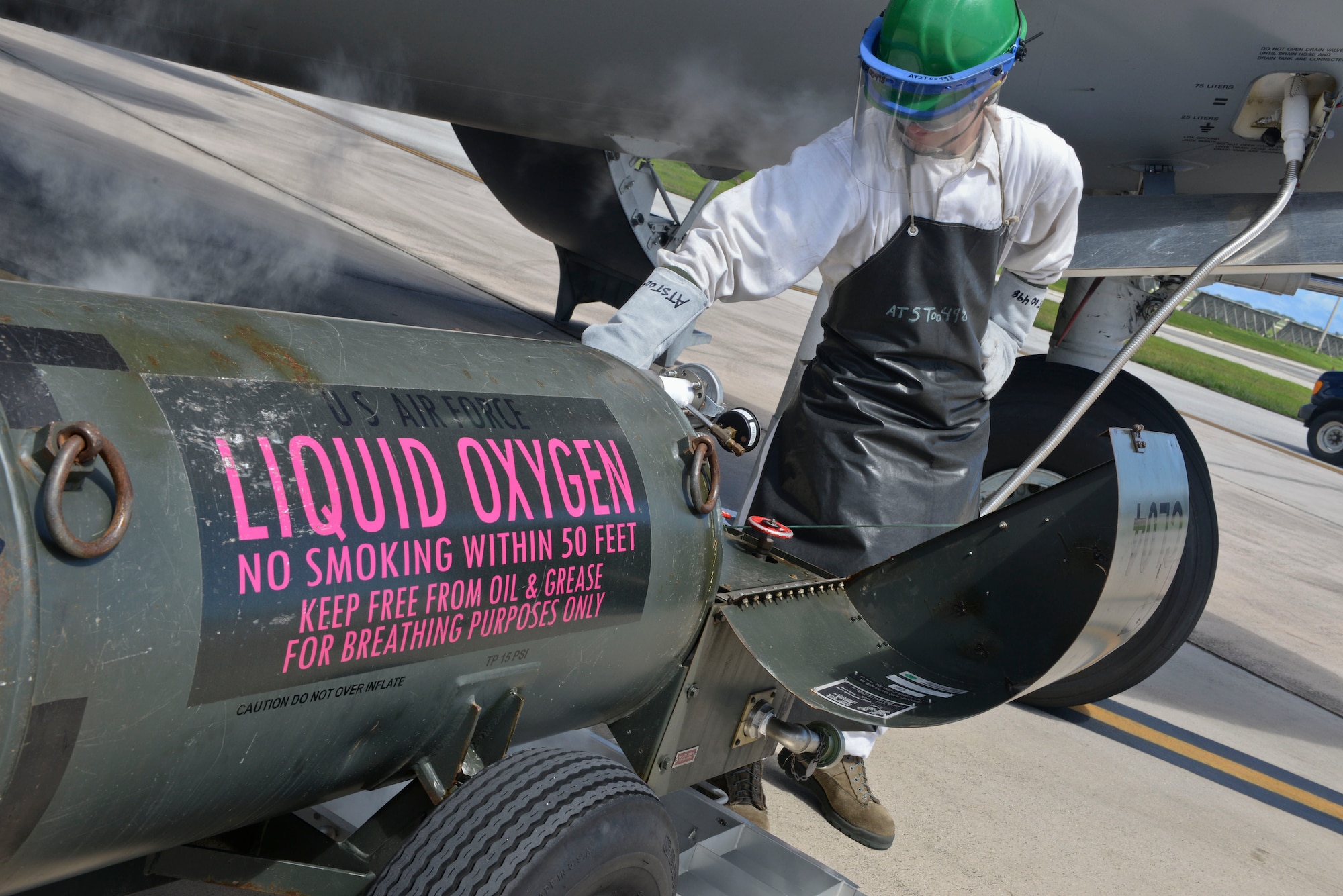 Senior Airman Blake Arquette, 734th Air Mobility Squadron communication and navigation journeyman, pumps liquid oxygen into a C-17 Globemaster Nov. 14, 2014, at Andersen Air Force Base, Guam. The 734th AMS Airmen worked on aircraft that directly supported President Barack Obama during his trip to Asia this month. (U.S. Air Force photo by Staff Sgt. Robert Hicks/Released)  