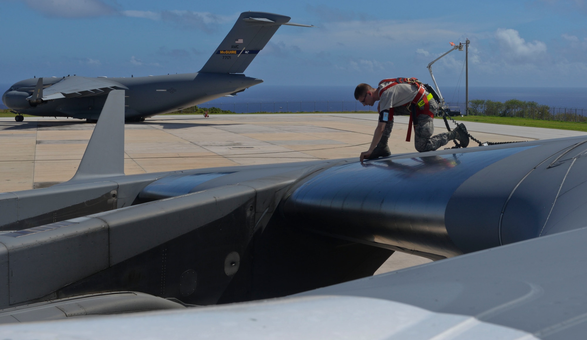 Senior Airman Evan Tweed, 734th Air Mobility Squadron guidance and control journeyman, prepares to check a fuel probe on a C-17 Globemaster Nov. 14, 2014, at Andersen Air Force Base, Guam. The 734th AMS Airmen worked on aircraft that directly supported President Barack Obama during his trip to Asia this month. (U.S. Air Force photo by Staff Sgt. Robert Hicks/Released) 