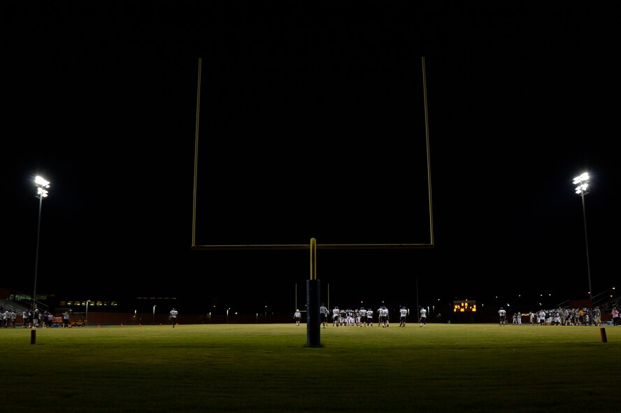 The football field at Legacy High School in Las Vegas is illuminated as the freshman and junior varsity teams compete as part of the school’s homecoming events Oct. 3, 2014. Legacy players won both games and set the stage for the varsity team. (U.S. Air Force photo by Tech. Sgt. Nadine Barclay/RELEASED)
