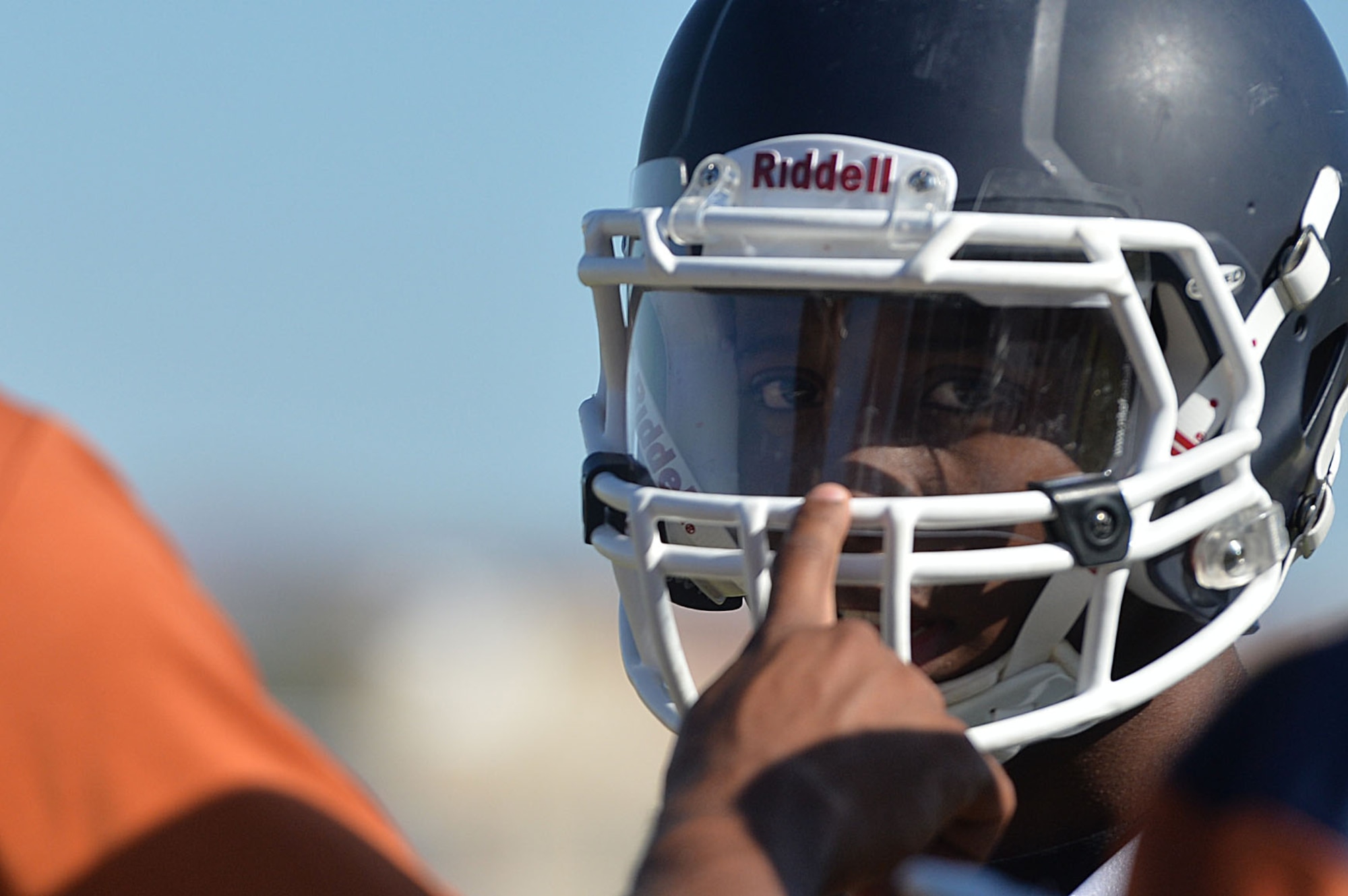 A Legacy High School football player receives feedback from Staff Sgt. Ryan Davis, defensive coordinator, on mistakes made during the team’s practice in Las Vegas Oct. 1, 2014. Davis, a 99th Ground Combat Training Squadron combat arms training and maintenance instructor stationed at Creech Air Force Base, Nevada, started coaching at the school after a motorcycle accident left him unable to play. Davis previously played semi-professional football for a team at Mountain Home AFB, Idaho. (U.S. Air Force photo by Tech. Sgt. Nadine Barclay/RELEASED)
