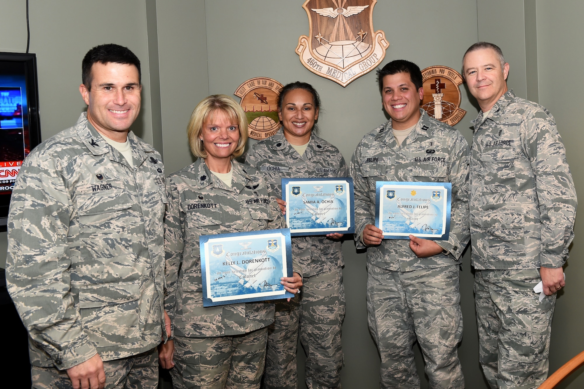 Col. John Wagner, 460th Space Wing commander, left, and Col. Michael Kindt, 460th Medical Group commander, right, surprised three medical group officers with news of their promotion selection Nov. 24, 2014, on Buckley Air Force Base, Colo. The members selected for promotion are, from second from left, Lt. Col. Kelly Dorenkott, 460th Medical Operations Squadron commander, Lt. Col. Samia Ochia, 460th Medical Group staff chief and Capt. Alfred Felipe, 460th Medical Group Bioenvironmental Engineering officer in charge. (U.S. Air Force photo by Airman 1st Class Samantha Saulsbury/Released)