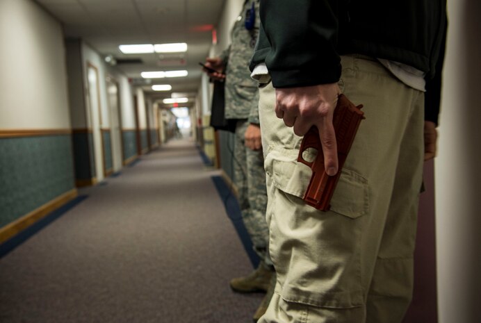 Lloyd Greenawalt, a 628th Security Forces Squadron patrolman, acts as a gunman during an active-shooter exercise to test the preparedness and response of the 628th Military Personnel Flight Nov. 21, 2014, at Joint Base Charleston, S.C. The drill was a test run for an upcoming base-wide, active-shooter exercise scheduled for early December, an annual requirement for Air Force installations. (U.S. Air Force photo/Senior Airman Jared Trimachi)