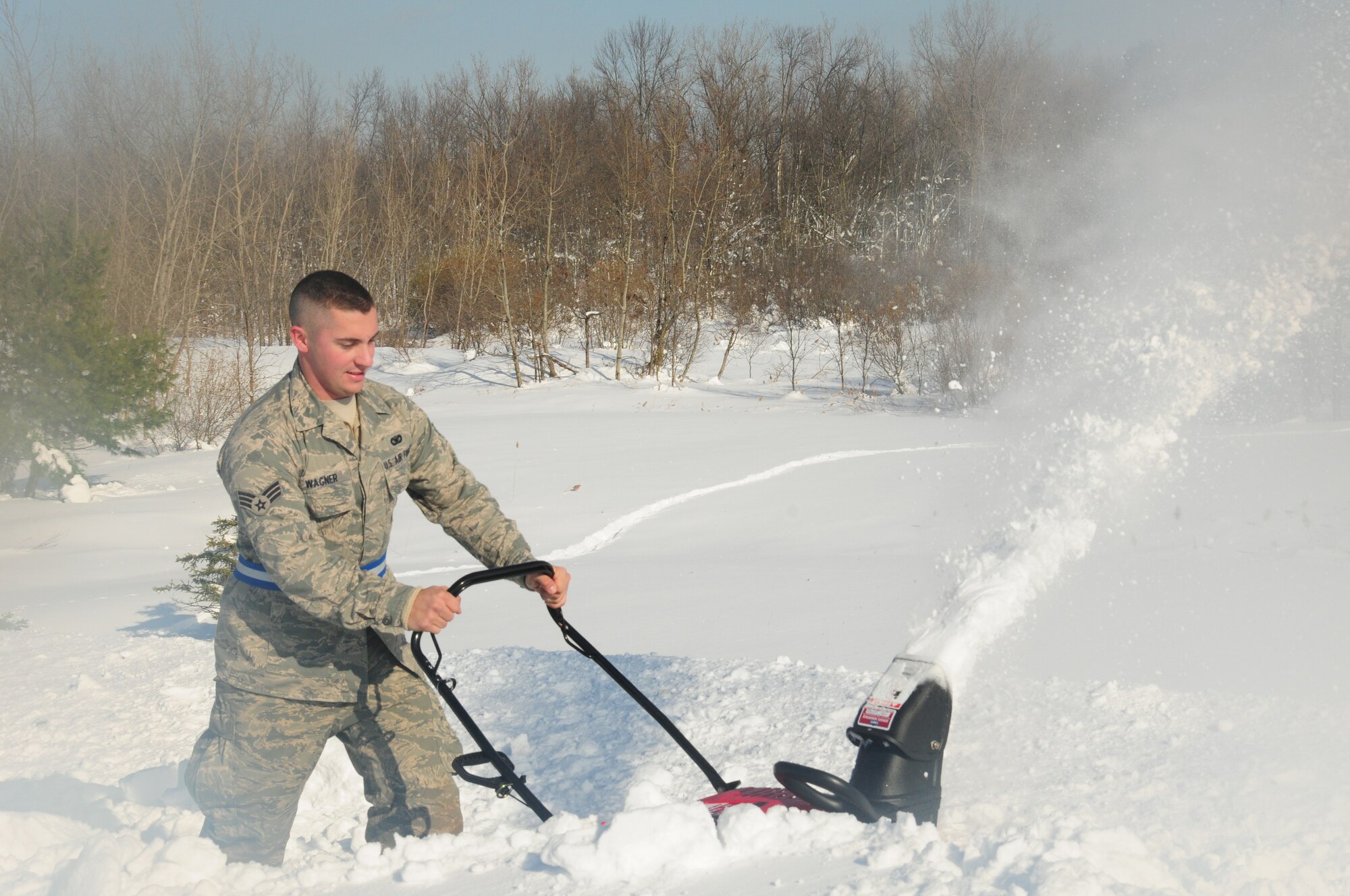 Senior Airman Robert Wagner from 107th Airlift Wing Security Forces takes part in removing the four feet of snow off the roof of Eden Heights Assisted Living Facility in West Seneca, New York from the snow storm that hit the Western New York area on Nov 18, 2014. (U.S. Air National Guard photo by Senior Master Sgt. Raymond Lloyd).