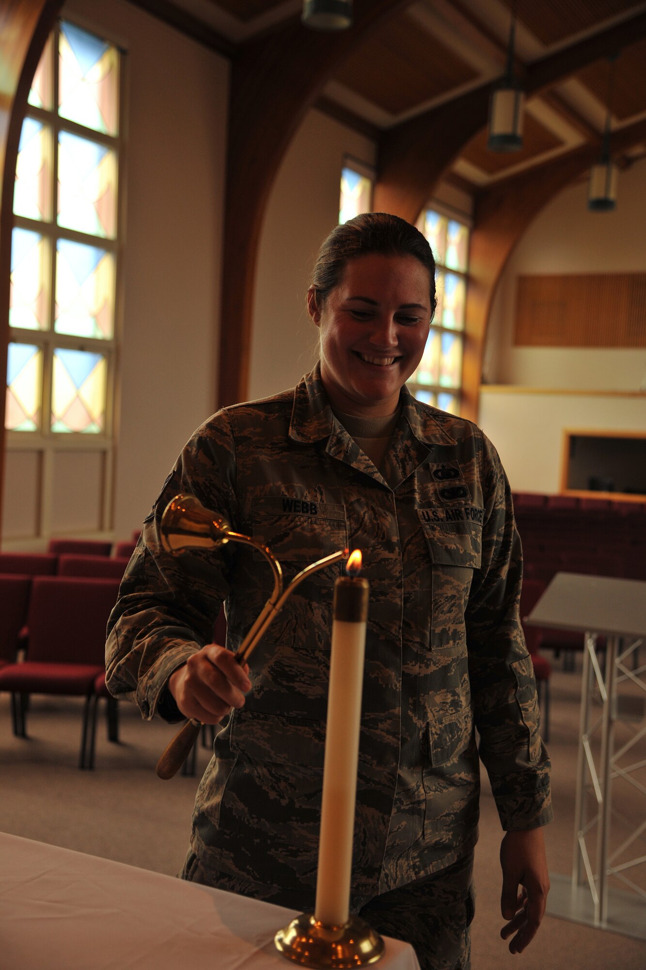 Staff Sgt. Nikki Webb, 319th Air Base Wing chaplain assistant, lights a candle in the chapel sanctuary for a worship service at Grand Forks Air Force Base, N.D. Sept. 24, 2014. Chaplain assistants’ duties involve taking care of the logistical aspects of worship services and different events that the chaplains coordinate. (U.S. Air Force photo/Senior Airman Xavier Navarro)