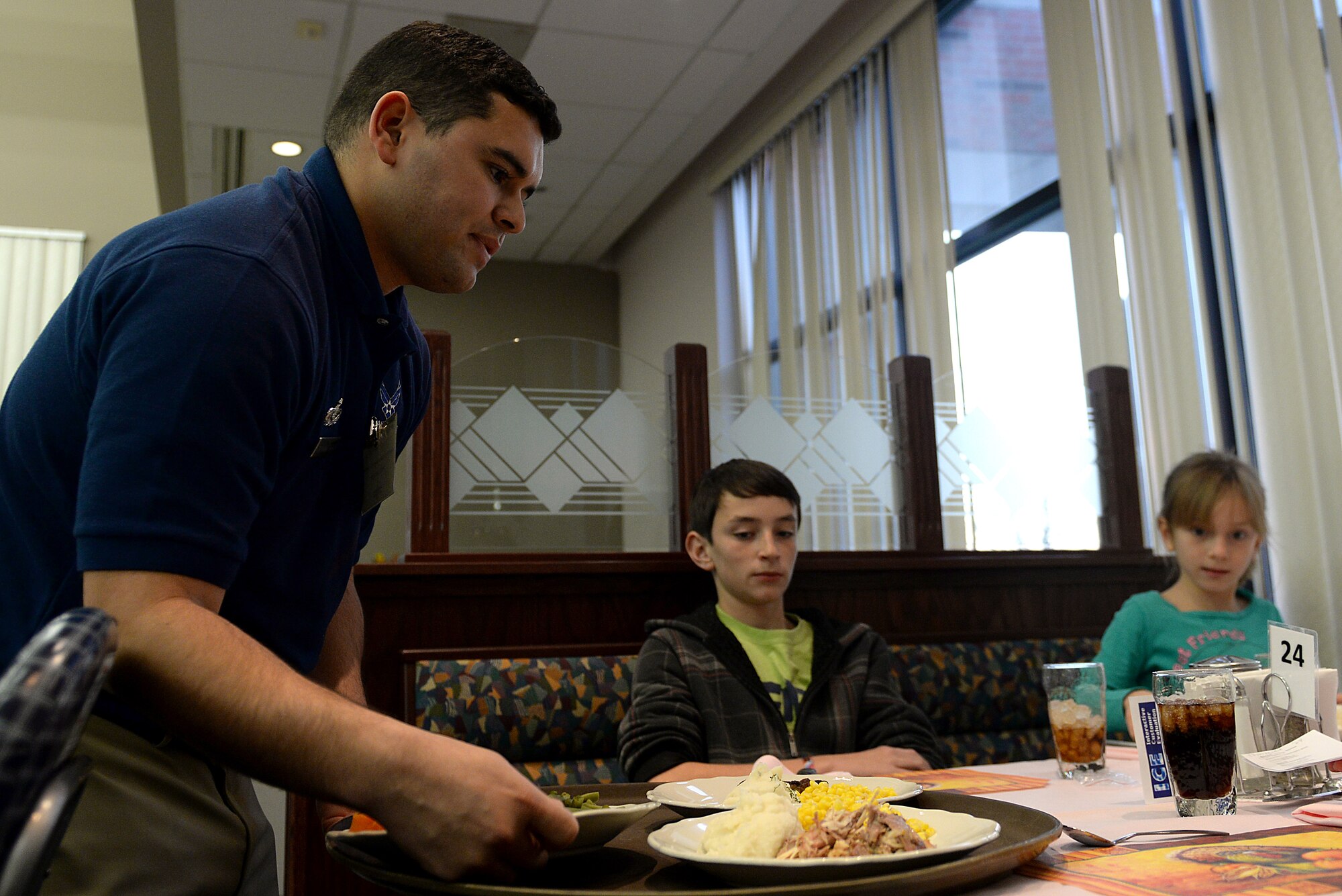 Volunteers from the NCO Council helped serve families of deployed servicemembers during a dinner Nov. 14, 2014 at Scott Air Force Base, Ill. The dinner was held at the dining facility and hosted by the Hearts Apart Program. The program is dedicated to family members and their deployed airman. (U.S. Air Force photo/ Airman 1st Class Kiana Brothers)