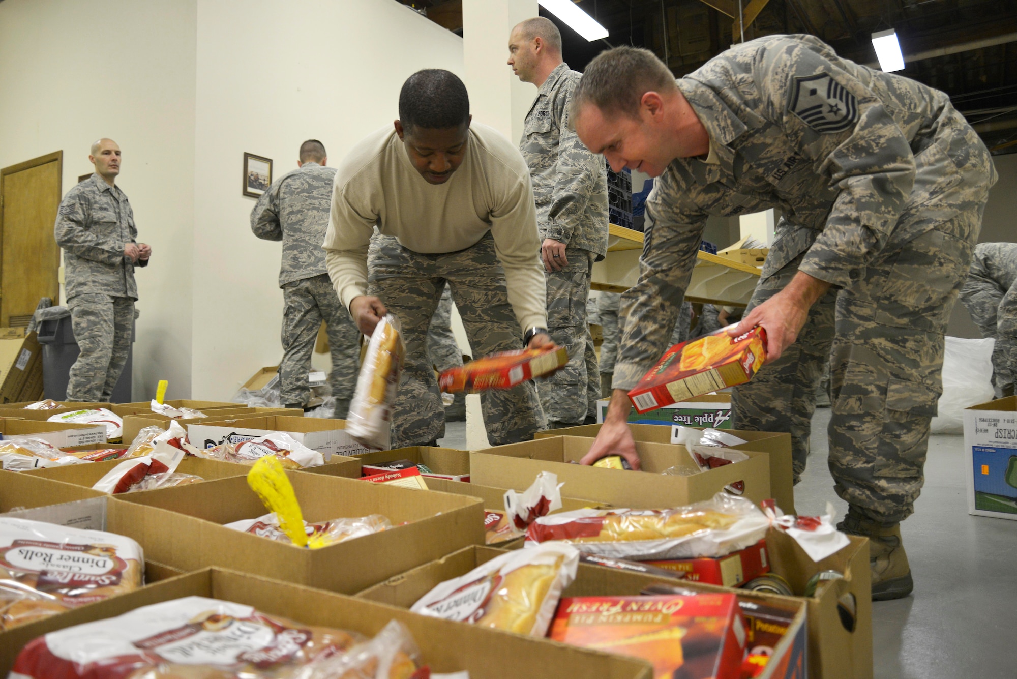 Fairchild’s First Sergeant Council and volunteers load boxes of complete Thanksgiving meals during the First Sergeants’ annual Turkey Drive Nov. 24, 2014, at Fairchild Air Force Base, Wash. The event is part of Operation Warm Heart, a First Sergeant Council outreach program designed to support Airmen during the holiday season. (U.S. Air Force photo/Airman 1st Class Janelle Patiño)