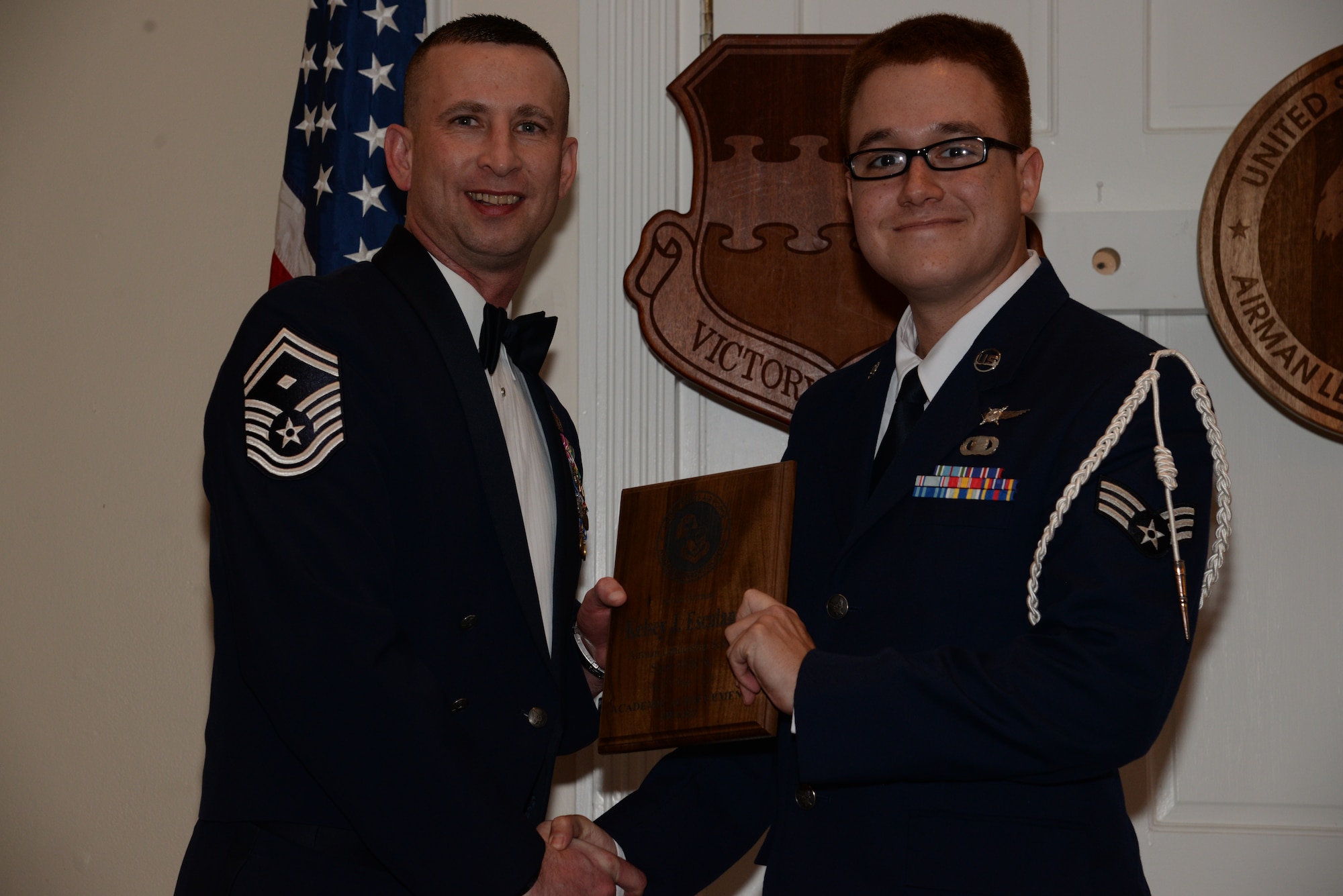 U.S. Air Force Senior Airman Kelsey Escalante, 5th Intelligence Squadron, receives the Senior Master Sgt. David B. Reid Airman Leadership School Academic Achievement award from Senior Master Sgt. Johnny Hamm, U.S. Air Forces Central first sergeant, during the ALS Class 15-1 graduation at Shaw Air Force Base, S.C., Nov. 21, 2014. This award is given to the student with the highest point total. (U.S. Air Force photo by Airman 1st Class Jonathan Bass/Released)