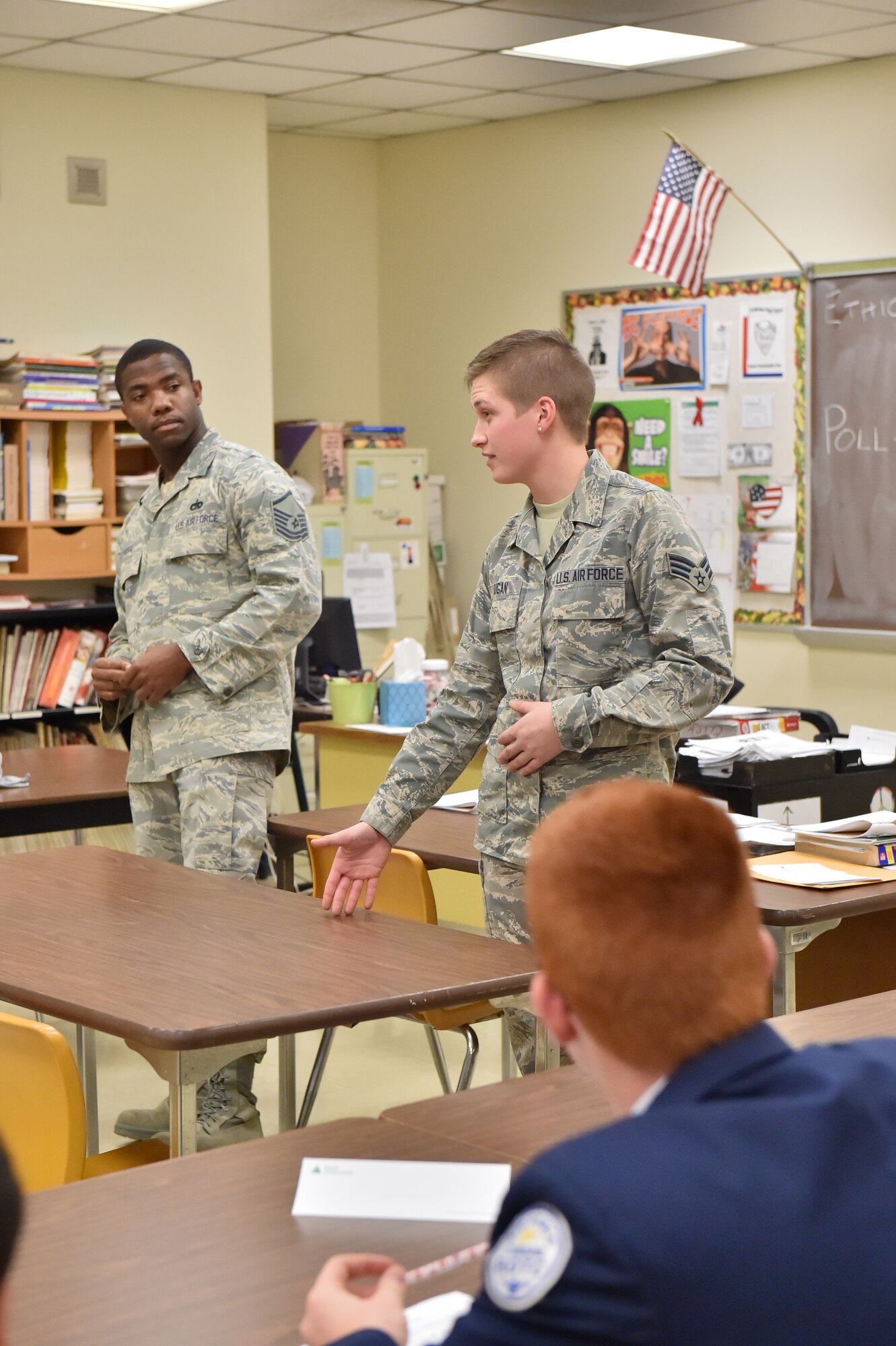 Senior Airman Nadeya Dugan, a Communication and Navigation Systems Journeyman with the 910th Aircraft Maintenance Squadron, shares life experiences with students at Lordstown High School, Nov. 13, 2014, as Master Sgt. Dartanion Pittrell, a 910th Airlift Wing Air Force Reserve Recruiter, watches. Several Airmen from the 910th Airlift Wing volunteered to teach a Junior Achievement ethics course at the school. (U.S. Air Force photo/Eric M White)