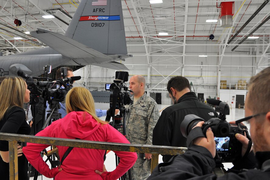 YOUNGSTOWN AIR RESERVE STATION, Ohio – Air Force Reserve Col. James Dignan, 910th Airlift Wing Commander, talks with local media representatives during an interview session in a hangar here, Nov. 24, 2014. The wing commander spoke with Mahoning Valley media as part of an installation visit by Ohio U.S. Senator Sherrod Brown. The senator visited YARS to meet with installation leadership and discuss his legislation to ensure upgrades are made to Ohio's Air Force Reserve and Air National Guard C-130 fleet by 2020 to meet federal and international airspace regulatory constraints. U.S. Air Force photo by Master Sgt. Bob Barko Jr.