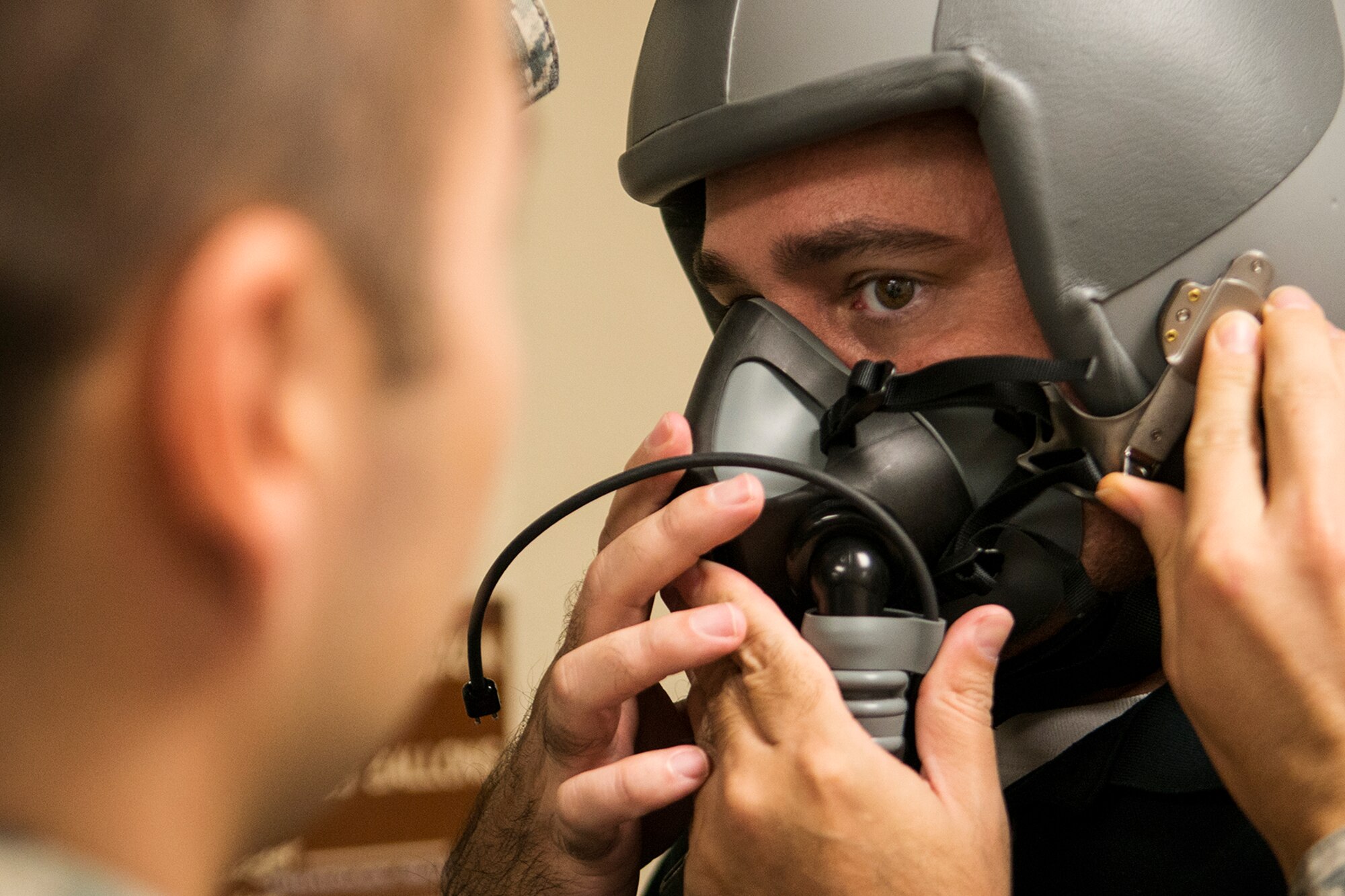 Jose Ramos is fitted with a helmet and oxygen mask in preparation for a flight on a B-52H Stratofortress, Nov. 20, 2014, Barksdale Air Force Base, La. Ramos is an aviation photographer and is writing a story on the 93rd Bomb Squadron and the B-52H Stratofortress for Combat Aircraft Monthly magazine. (U.S. Air Force photo by Master Sgt. Greg Steele/Released)