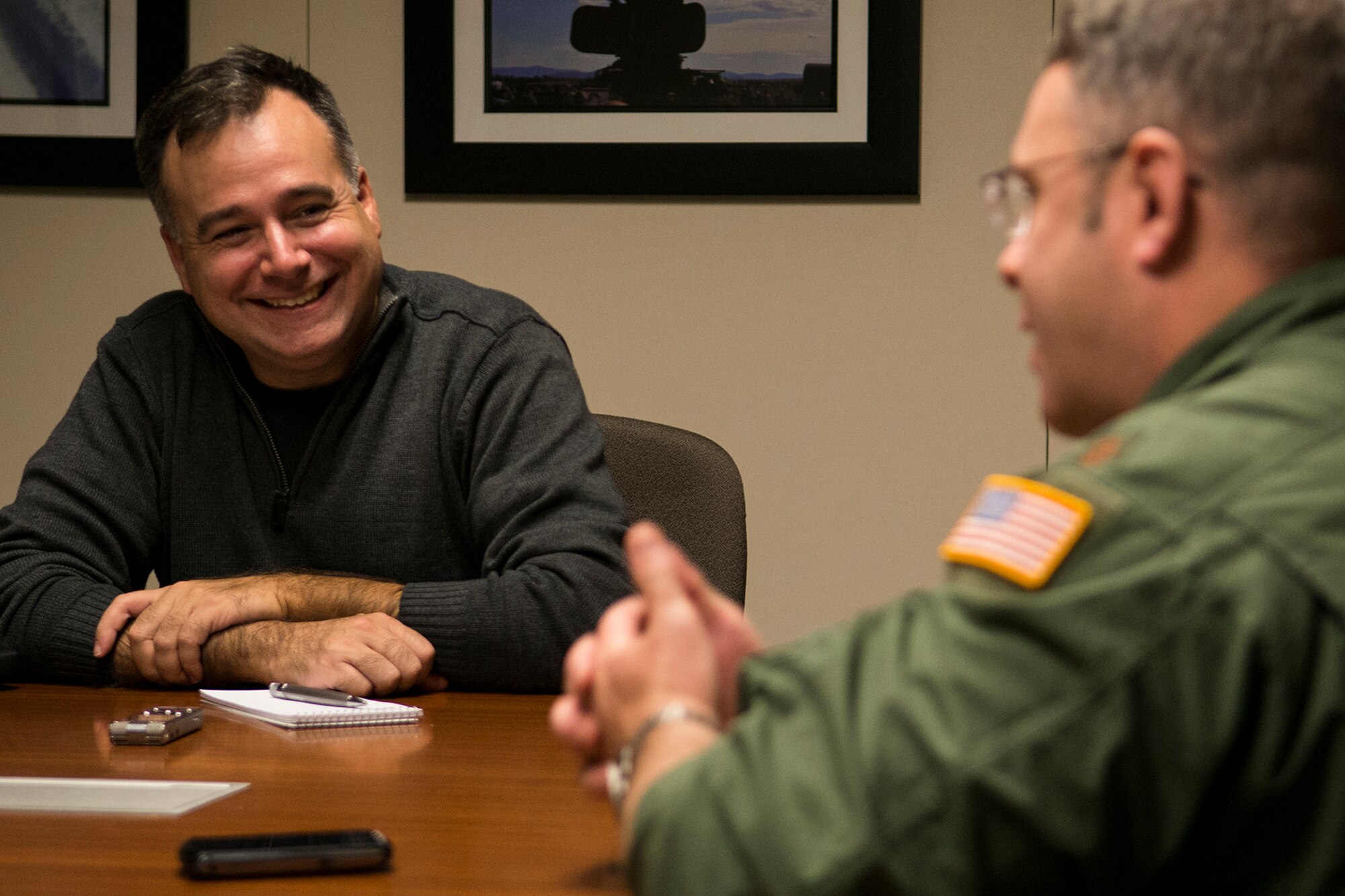 Jose Ramos interviews U.S. Air Force Maj. Adam Price, 11th Bomb Squadron B-52 aircrew member, Nov. 19, 2014, Barksdale Air Force Base, La. Ramos is an aviation photographer and is writing a story on the 93rd Bomb Squadron and the B-52H Stratofortress for Combat Aircraft Monthly magazine. (U.S. Air Force photo by Master Sgt. Greg Steele/Released)