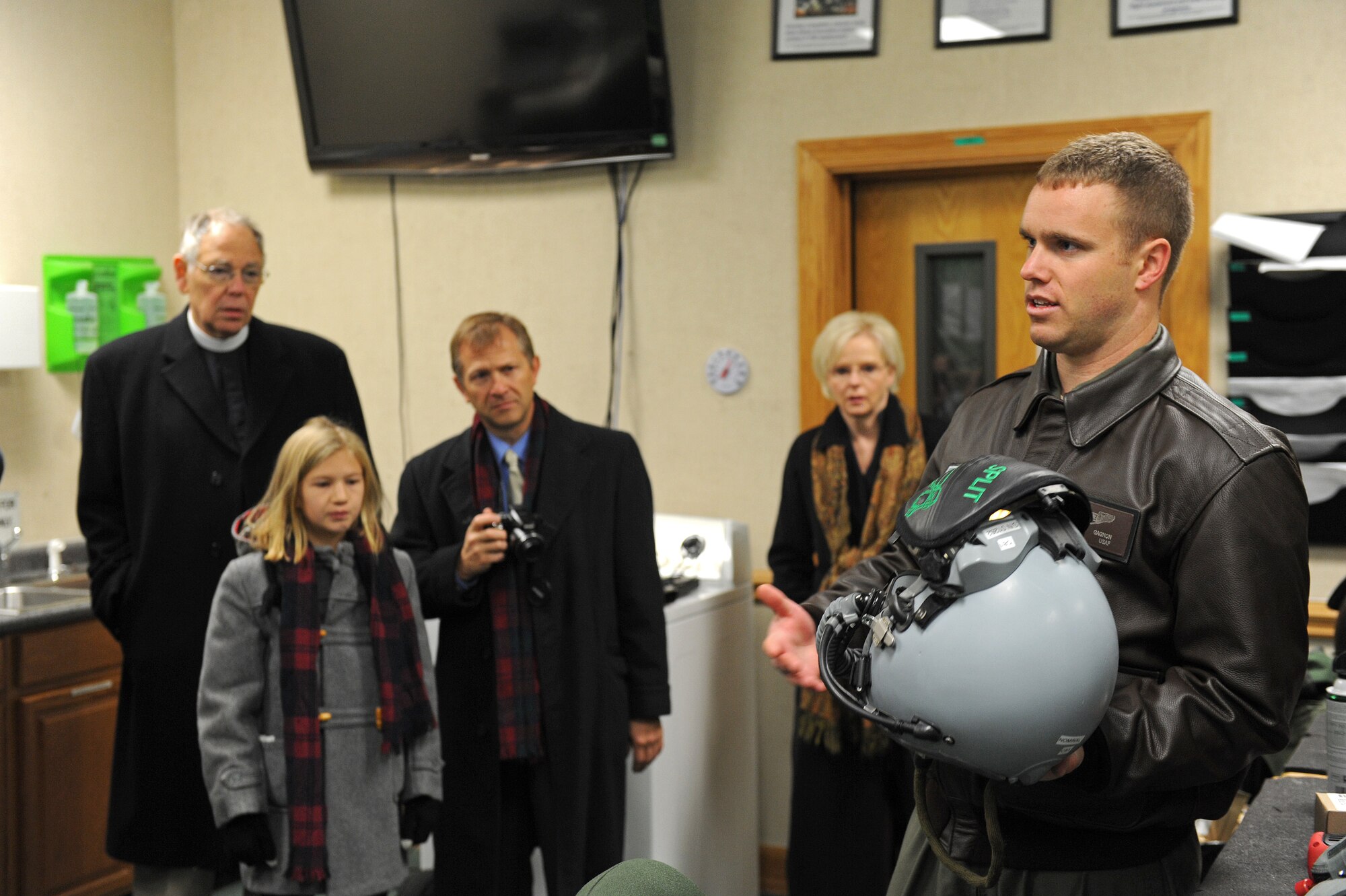 Capt. Chad Gagnon, 335th Fighter Squadron pilot, discusses aircrew equipment with family and friends of Capt. William Jarman Jr., an F-4 Phantom pilot with the 335th Tactical Fighter Squadron during the 1960s, who died in 1969 during an aircraft collision over Fort Bragg, North Carolina, at Seymour Johnson Air Force Base, North Carolina, Nov. 14, 2014. Jarman’s family and friends visited the base to connect with the Airmen of the 335th FS, a squadron Jarman dedicated his life to. (U.S. Air Force photo/Airman 1st Class Aaron Jenne)