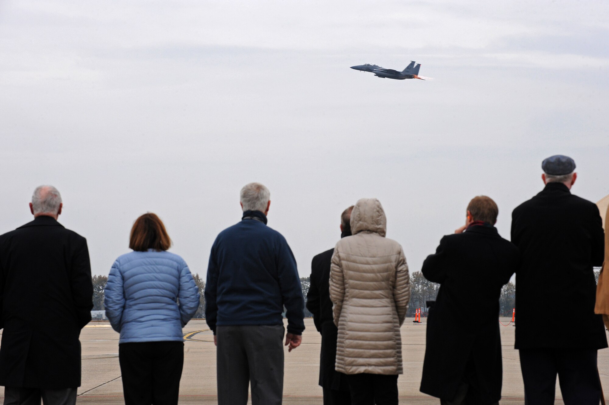 Family and friends of Capt. William Jarman Jr., an F-4 Phantom pilot with the 335th Tactical Fighter Squadron during the 1960s, who died in 1969 during an aircraft collision over Fort Bragg, North Carolina, watch as an F-15E Strike Eagle takes off from Seymour Johnson Air Force Base, North Carolina, Nov. 14, 2014. Jarman’s family and friends visited the base to connect with the Airmen of the 335th Fighter Squadron, a squadron Jarman dedicated his life to. (U.S. Air Force photo/Airman 1st Class Aaron Jenne)