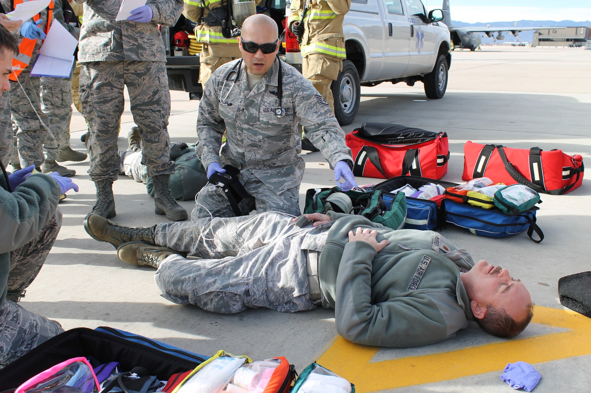 PETERSON AIR FORCE BASE, Colo. – Medical personnel from the 21st Medical Group triage ill crewmembers while trying to determine the cause of illness and the threat it may present to responding personnel during the Condor Crest base exercise Nov. 18. Condor Crest is a quarterly exercise designed to test and evaluate base readiness for real-word events. (U.S. Air Force photo/Michael Golembesky)