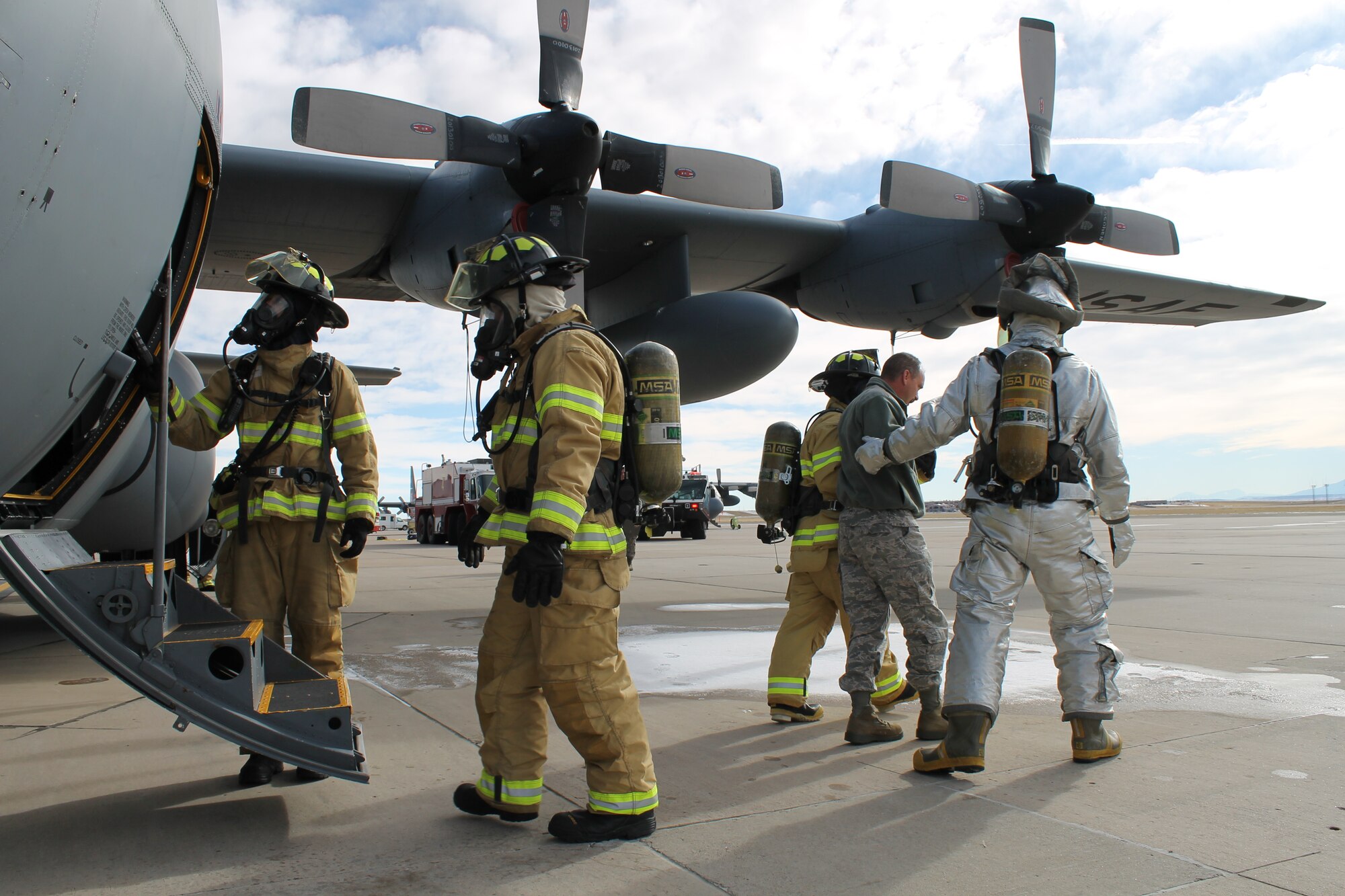 PETERSON AIR FORCE BASE, Colo. – Service members with the Peterson Air Force Base fire department evacuate the crew of a C-130 Hercules who had declared an in-flight emergency during a return flight from Holloman Air Force Base Nov. 18. Condor Crest is a quarterly exercise designed to test and evaluate base readiness for real-word events. (U.S. Air Force photo/Michael Golembesky)