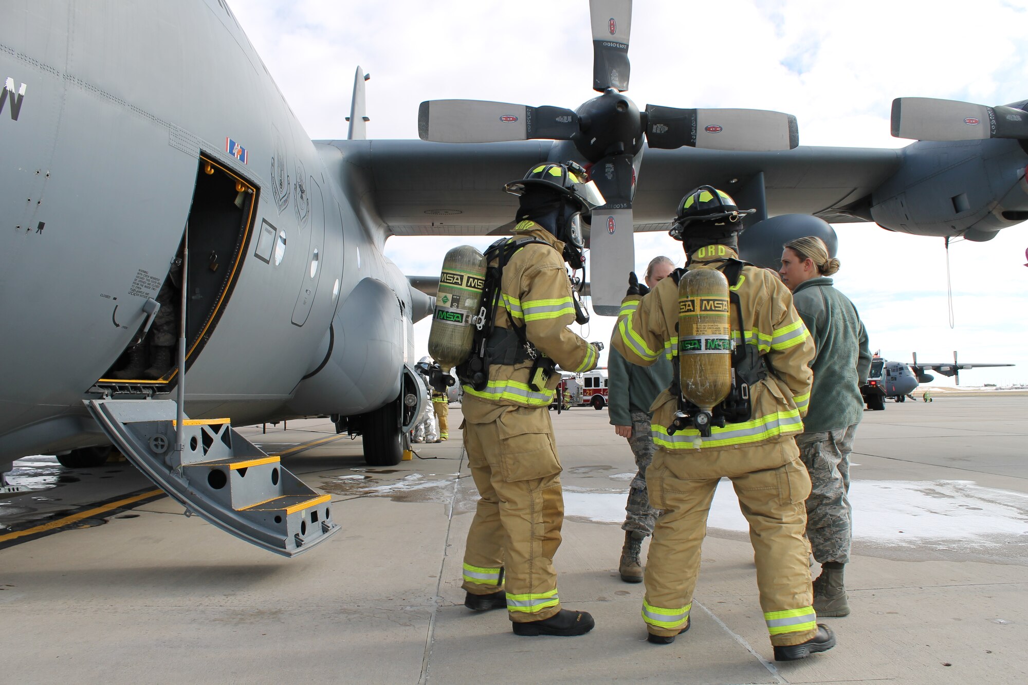PETERSON AIR FORCE BASE, Colo. –Peterson Air Force Base fire fighters question crewmembers during a base exercise that simulated foodborne illness among the crew members of a C-130 Hercules aircraft on the base flight line Nov. 18. Condor Crest is a quarterly exercise designed to test and evaluate base readiness for real-word events. (U.S. Air Force photo/Michael Golembesky)
