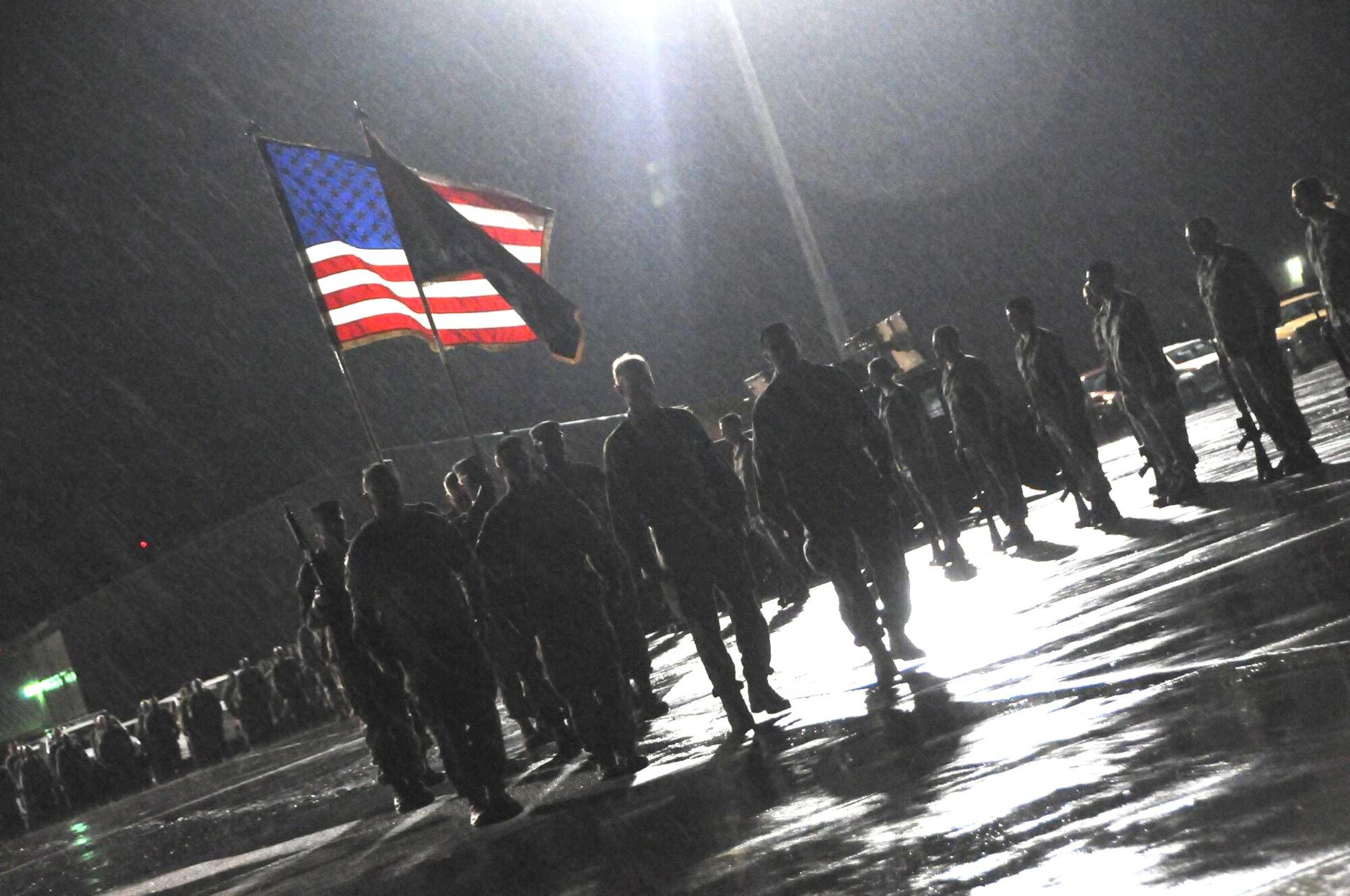 Chief Master Sgt. Max Grindstaff (right), the-then NATO Air Training Command and 438th Air Expeditionary Wing command chief, marches with a contingent of wing leaders on the Bagram Air Base flightline April 29, 2011. The group marched toward a C-17 waiting to begin the dignified transfer of nine Americans who lost their lives in an inside attack there April 27, 2011. Nearly 2,000 service members met on the flightline  to pay respect to the victims. Grindstaff now serves as command chief at the U.S. Air Force Academy. (Courtesy photo) 