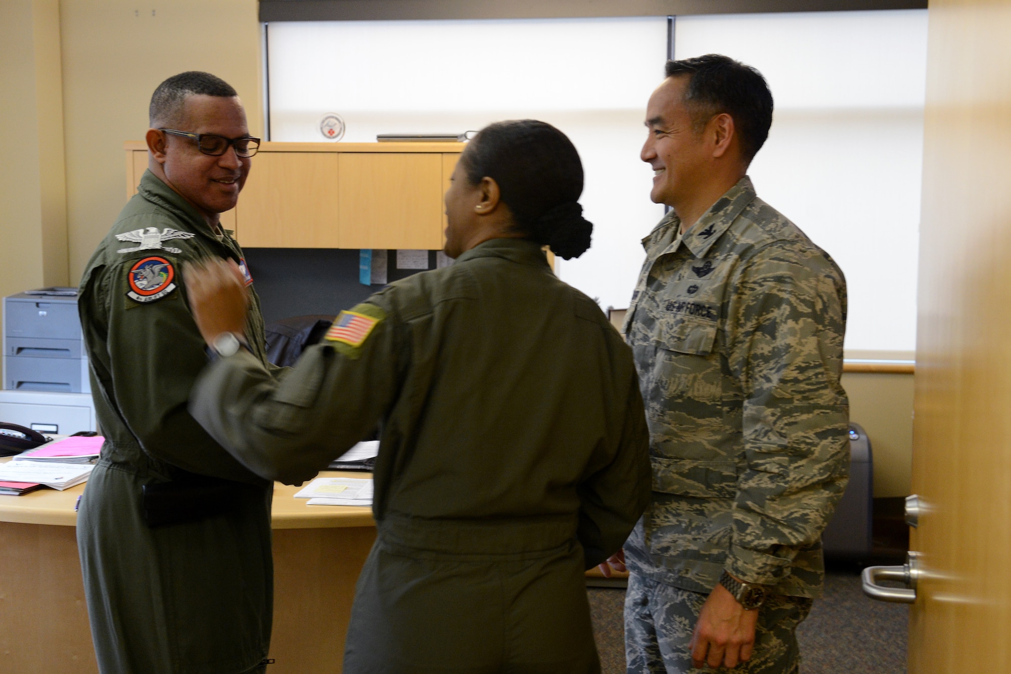 Lt. Col. Robert Craiggray (left), 62nd Medical Squadron chief aerospace medicine, receives a promotion certificate to Colonel from Col. David Kumashiro (right), 62nd Airlift Wing commander, Nov. 24, 2014, at Joint Base Lewis-McChord, Wash.  Craiggray was the only lieutenant colonel to receive this news for Team McChord and has a projected date of rank of May 2016. (U.S. Air Force photo/Airman 1st Class Keoni Chavarria)
