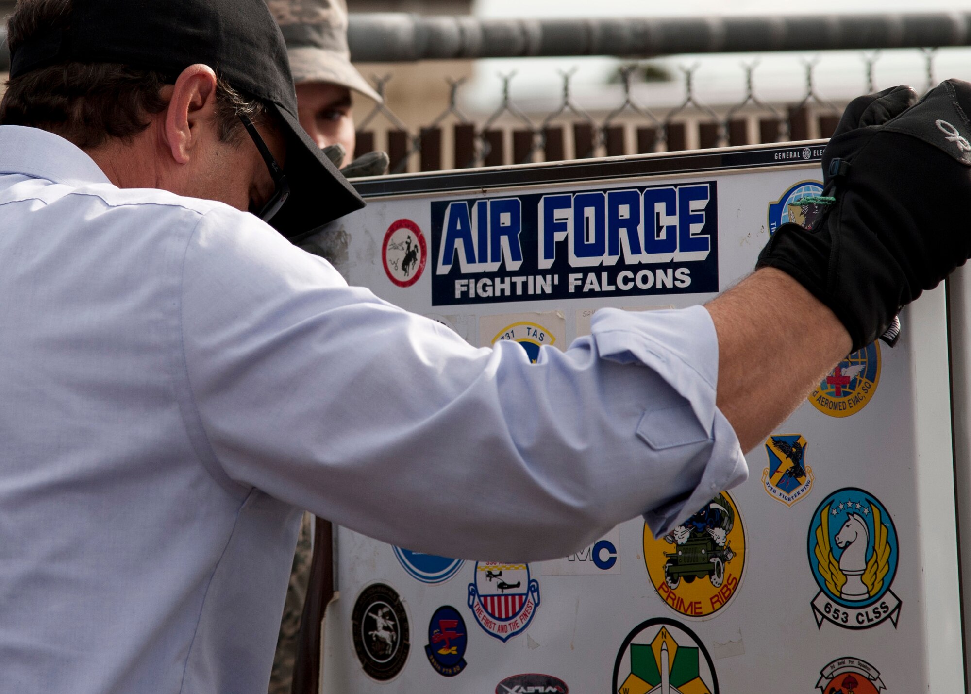 PETERSON AIR FORCE BASE, Colo. – David Anderson, 21st Civil Engineer Squadron environmental program manager, collects a non-compliant refrigerator during Operation Chill Out, Nov. 18, 2014. The Chill Out was an event where non-compliant refrigerators at 21st Space Wing installations were turned in for recycling or taken to the Defense Logistics Agency at Fort Carson. (Air Force photo by Senior Airman Tiffany DeNault)