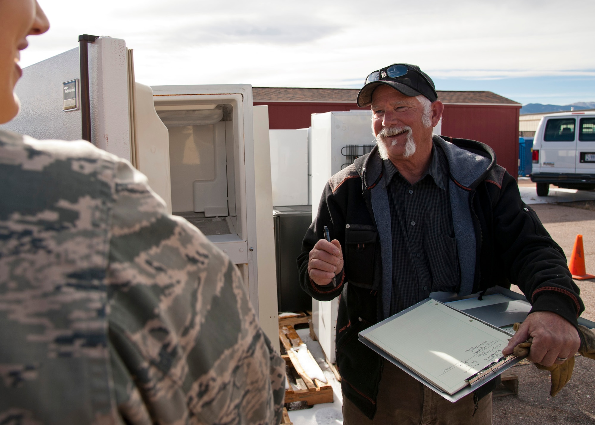 PETERSON AIR FORCE BASE, Colo. – Phil Chase, 21st Civil Engineer Squadron environmental program manager, collects information on non-compliant refrigerators turned in at the 21 CES Environmental Office during the Operation Chill Out, Nov. 14, 2014. The Chill Out was an event where non-compliant refrigerators at 21st Space Wing installations were turned in for recycling or taken to the Defense Logistics Agency at Fort Carson. (Air Force photo by Senior Airman Tiffany DeNault)