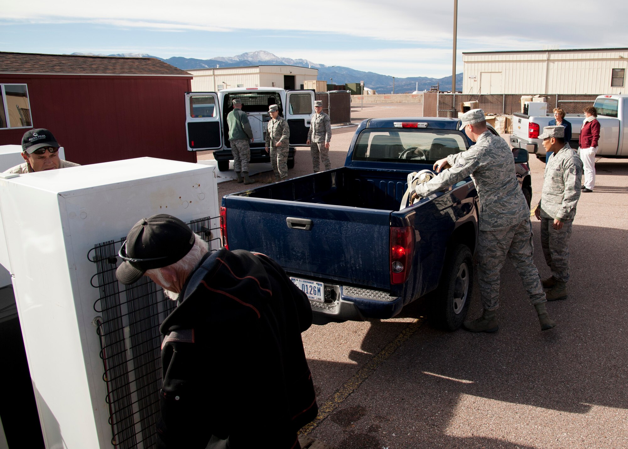 PETERSON AIR FORCE BASE, Colo. – Members of the 21st Space Wing drop off non-compliant refrigerators at the 21st Civil Engineer Squadron environmental office during Operation Chill Out, Nov. 18, 2014. The Chill Out was an event where non-compliant refrigerators at 21st Space Wing installations were turned in for recycling or taken to the Defense Logistics Agency at Fort Carson. (Air Force photo by Senior Airman Tiffany DeNault)