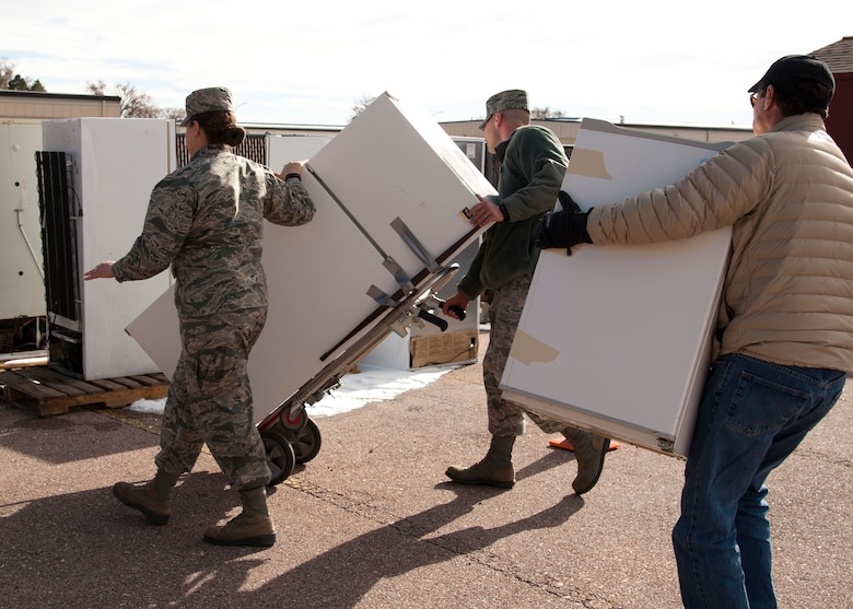 PETERSON AIR FORCE BASE, Colo. – Members of the 21st Space Wing drop off non-compliant refrigerators at the 21st Civil Engineer Squadron environmental office during Operation Chill Out, Nov. 18, 2014. The Chill Out was an event where non-compliant refrigerators at 21st Space Wing installations were turned in for recycling or taken to the Defense Logistics Agency at Fort Carson. (Air Force photo by Senior Airman Tiffany DeNault)