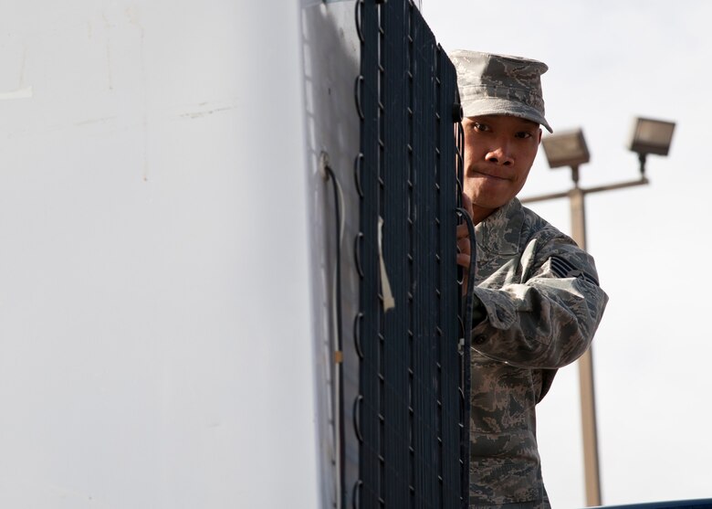 PETERSON AIR FORCE BASE, Colo. – Staff Sgt. Joseph Swe, 21st Communications Squadron, drops off a non-compliant refrigerator at the 21st Civil Engineer Squadron environmental office during Operation Chill Out, Nov. 18, 2014. The Chill Out was an event where non-compliant refrigerators at 21st Space Wing installations were turned in for recycling or taken to the Defense Logistics Agency at Fort Carson. (Air Force photo by Senior Airman Tiffany DeNault)