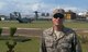 Maj. Kyle Johnson, Africa Command detachment commander, 2nd Joint Communications Squadron, Joint Communications Support Element, pauses for a photo in front of an MV-22 Osprey; the city of Monrovia, Liberia, rises in the background.