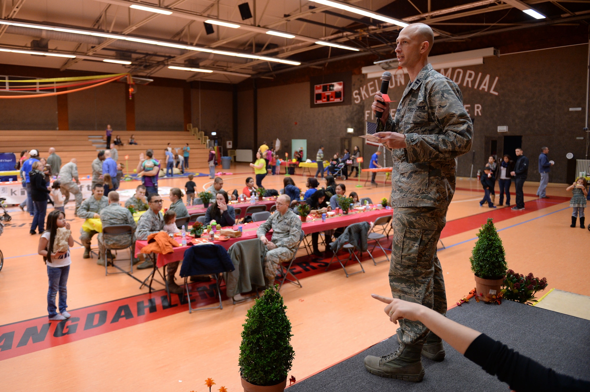 U.S. Air Force Chaplain (Capt.) Aaron Thorne, coordinator of Spantacular Family Fall Festival, selects a prize winner during the event Nov. 21, 2014, in the Skelton Memorial Fitness Center at Spangdahlem Air Base, Germany. Thorne drew names to randomly select participants to receive gifts. (U.S. Air Force photo by Staff Sgt. Daryl Knee/Released)


