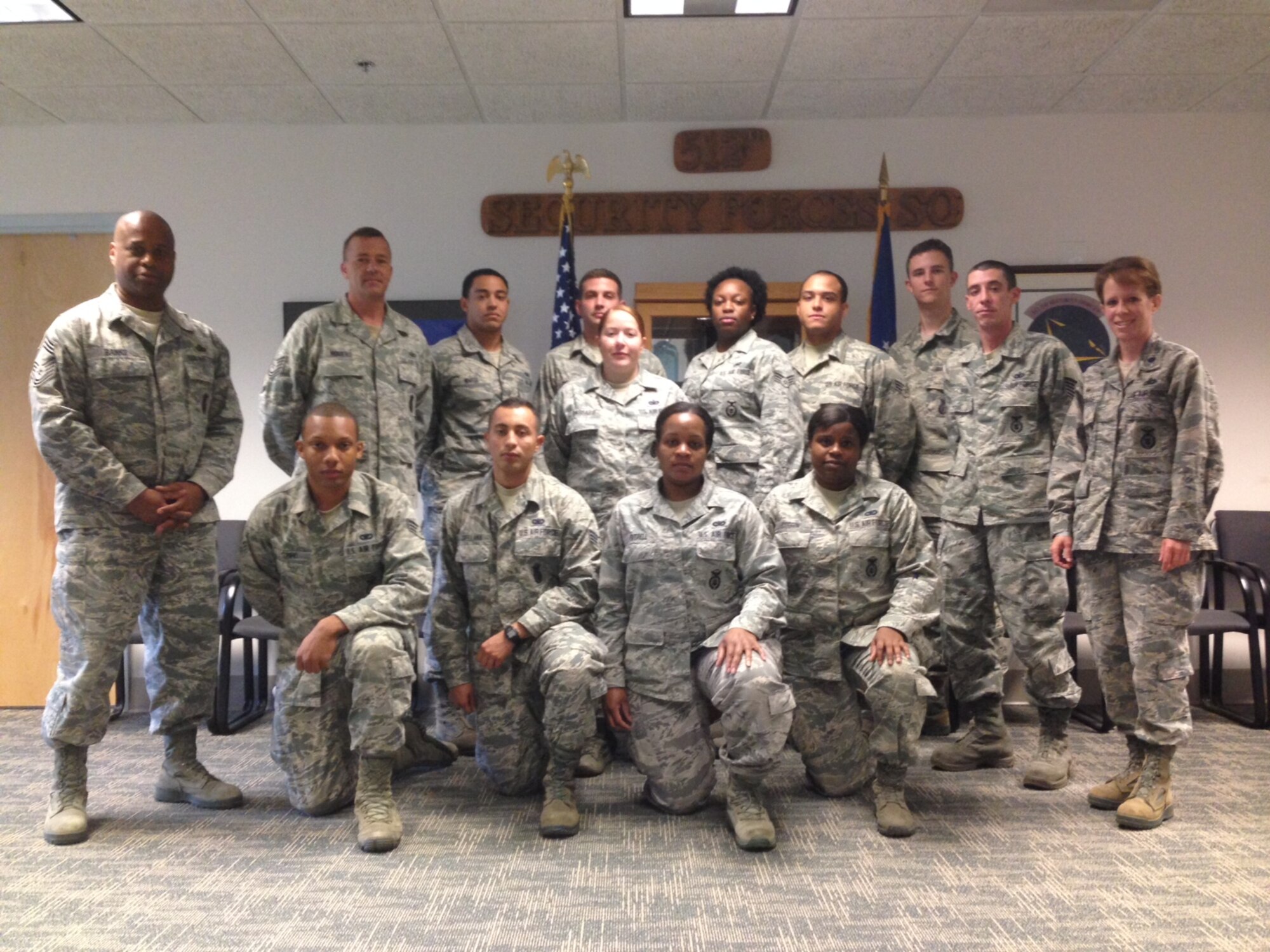 Members from the 512th Security Forces Squadron gather together for a group photo, prior to delploying to Southwest Asia for a six-month tour, in support of the Global War on Terror. 