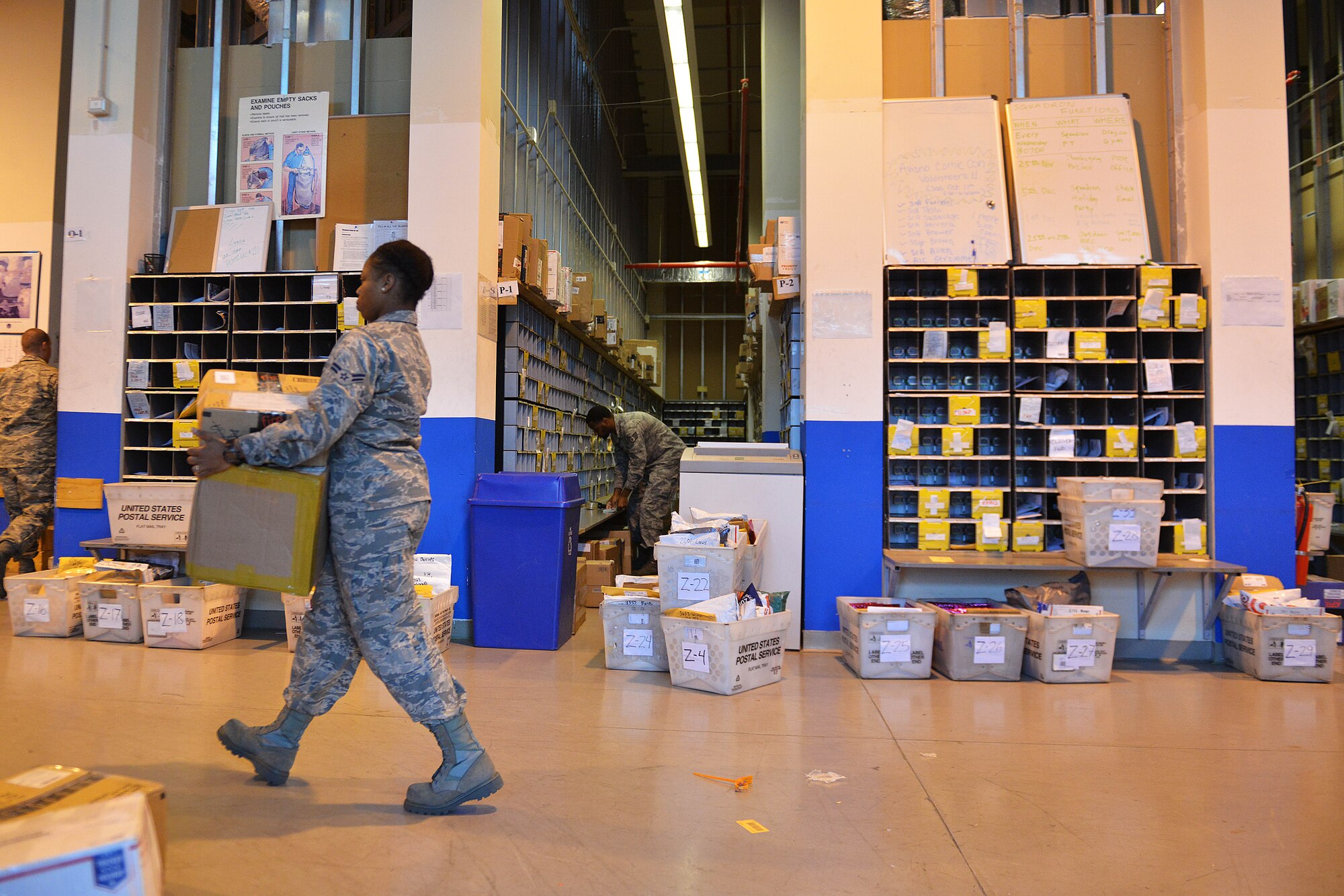 Postal clerks with the 31st Communications Squadron sort inbound mail, Nov. 25, 2014, at Aviano Air Base, Italy. The post office supports Team Aviano's mission by providing timely inbound and outbound postal services for more than 7,500 service members, dependents and civilians assigned to the installation. To ensure on-time delivery during the holiday season, volunteer postal workers help sort, pitch, process and hand out mail parcels to customers. (U.S. Air Force photo/Airman 1st Class Ryan Conroy)