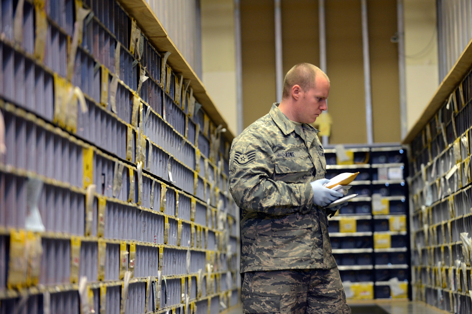 Staff Sgt. Andrew Rowe, 31st Communications Squadron postal clerk, distributes mail, Nov. 25, 2014, at Aviano Air Base, Italy.  During the holiday season, the post office receives approximately 60 percent more parcels. To help alleviate customer stress, the post office has extended it hours until Dec. 27 to 9 a.m. to 6 p.m., Monday through Friday. (U.S. Air Force photo/Airman 1st Class Ryan Conroy)