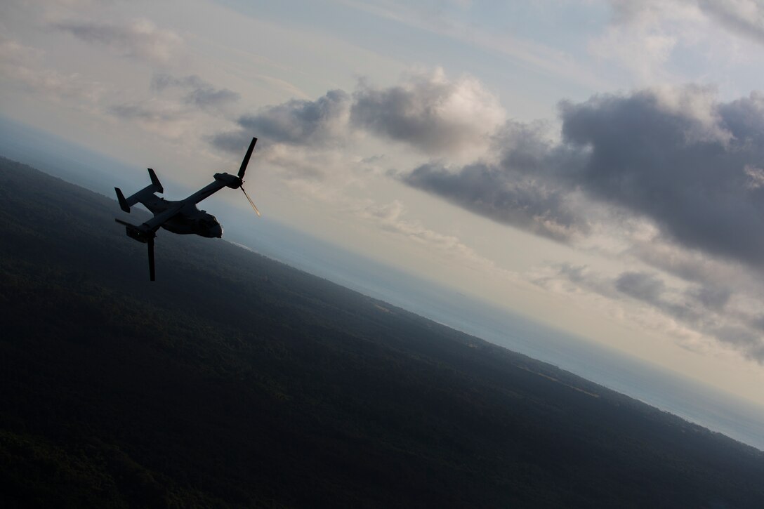 A U.S. Marine Corps MV-22B Osprey with SPMAGTF Crisis Response - Africa returns to base after dropping off supplies that will be used by local and international health organizations to build Ebola Treatment Units while in support of Operation United Assistance in Liberia, Nov. 21, 2014. United Assistance is a Department of Defense operation to provide command and control, logistics, training, and engineering support to U.S. Agency for International Development- led efforts to contain the Ebola virus outbreak in West African nations. (U.S. Marine Corps photo by Lance Cpl. Andre Dakis/SPMAGTF-CR-AF Combat Camera/Released)