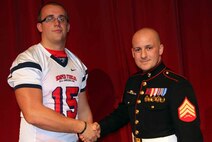 Grant Schmidt, an Offensive Tackle living in Sioux Falls, S.D. attending Roosevelt High School, ishakes the hand of Sgt. Ryan Fife, a recruiter from Sioux Falls, November 26. Schmidt was selected to play in the Marine Corps' Semper Fidelis All-American Bowl coming up this January. This rare opportunity is awarded to only those who the Marine Corps has determined best represent the core values of honor, courage and commitment. 
