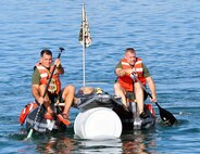 Lt. Col. Robert Bailey, director of the Amphibious Vehicle Test Branch, and Master Sgt. Michael Chouinard, AVTB staff noncommissioned officer in charge, row their team’s makeshift boat Nov. 21 at Camp Pendleton, Calif. AVTB, a subordinate unit of Marine Corps Systems Command, held its inaugural bathtub race where participants were challenged to build boats out of scavenged and recycled materials.