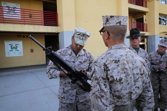 A Recruit of Golf Company, 2nd Recruit Training Battalion, stands at attention as he is inspected by the series commander during the Series Commander Inspection at Marine Corps Recruit Depot San Diego, Nov. 17. Other drill instructors swarmed the platoon creating chaos, testing the recruits bearing, one of the Marine Corps leadership traits.