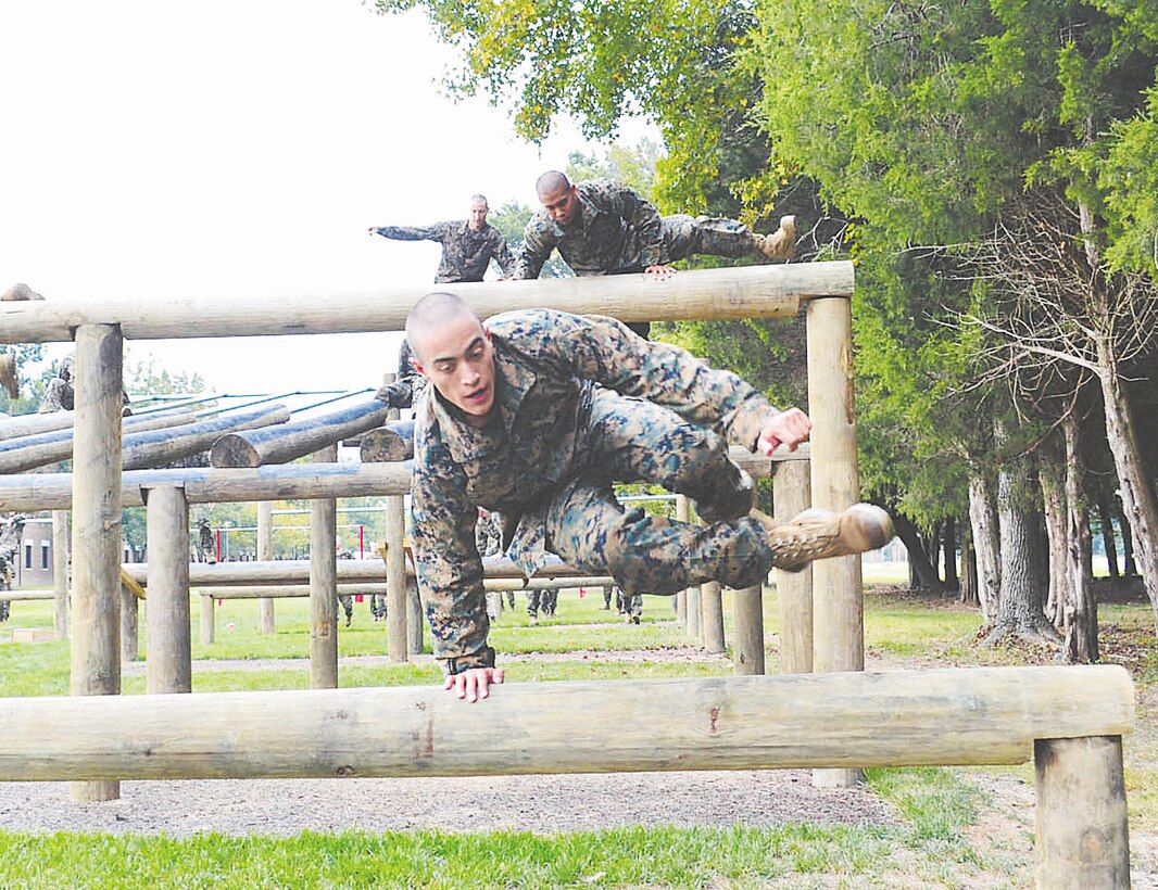 Steve Brackeen Turunc competes in an obstacle course during Officer Candidates School training during this undated photo taken aboard Marine Corps Base Quantico. Turunc, whose late grandfather commanded a Marine rifle platoon during the Vietnam War, was among the 169 OCS graduates on Tuesday.