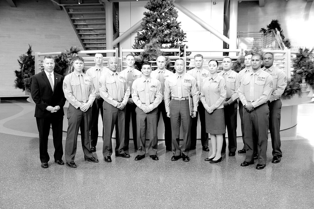 The 13 graduates of the first ever Career Course seminar for Marine Corps staff sergeants celebrate their successful course completion at the National Museum of the Marine Corps on Nov. 20. 