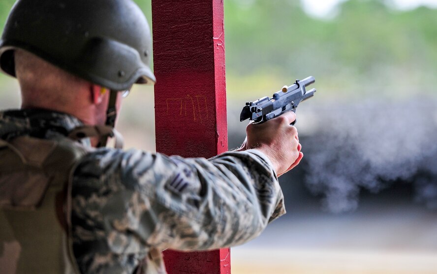 Senior Airman Nicholas Broll, 25th Intelligence Squadron intelligence analyst, fires his M9 pistol during small arms training at Hurlburt Field, Fla., Nov. 13, 2014. Combat Arms Training and Maintenance instructors train and qualify Airmen on required weapons needed for deployments. (U.S. Air Force photo/Airman 1st Class Jeff Parkinson)