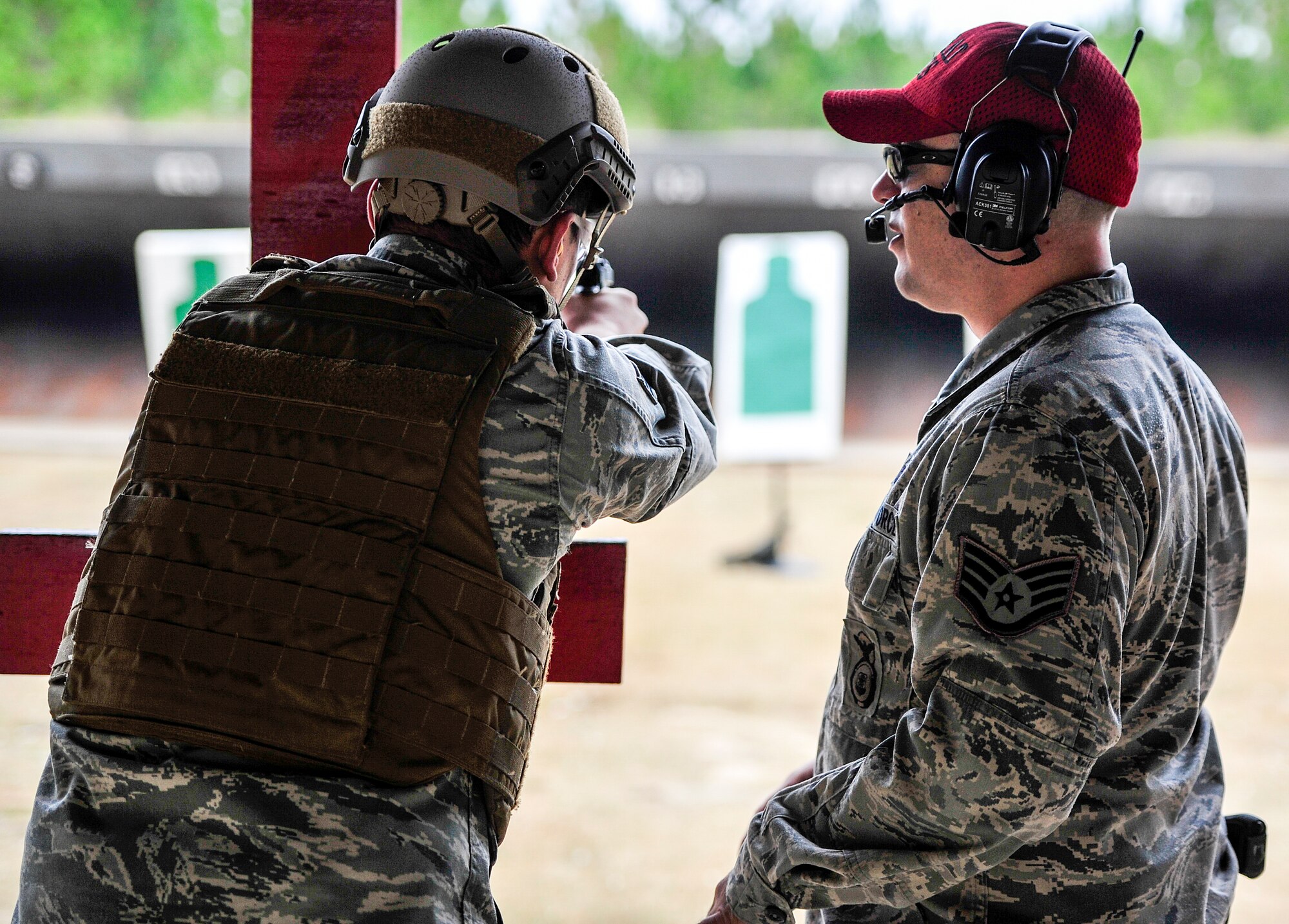 Staff Sgt. Casey Paine, 1st Special Operations Security Forces Squadron Combat Arms Training and Maintenance instructor, instructs Senior Airman Michael Diaz, 319th Special Operations Squadron aircrew flight equipment, during small arms training at Hurlburt Field, Fla., Nov. 13, 2014. CATM instructors train and qualify Airmen on required weapons needed for deployments. (U.S. Air Force photo/Airman 1st Class Jeff Parkinson)