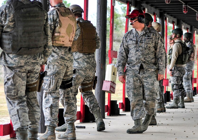 Staff Sgt. Casey Paine, 1st Special Operations Security Forces Squadron Combat Arms Training and Maintenance instructor, provides instruction during small arms training at the firing range on Hurlburt Field, Fla., Nov. 13, 2014. Hurlburt’s CATM range is the second busiest in the Air Force; they qualify approximately 6,000 students on the M9 pistol and 5,000 on the M4 rifle, annually. (U.S. Air Force photo/Airman 1st Class Jeff Parkinson)