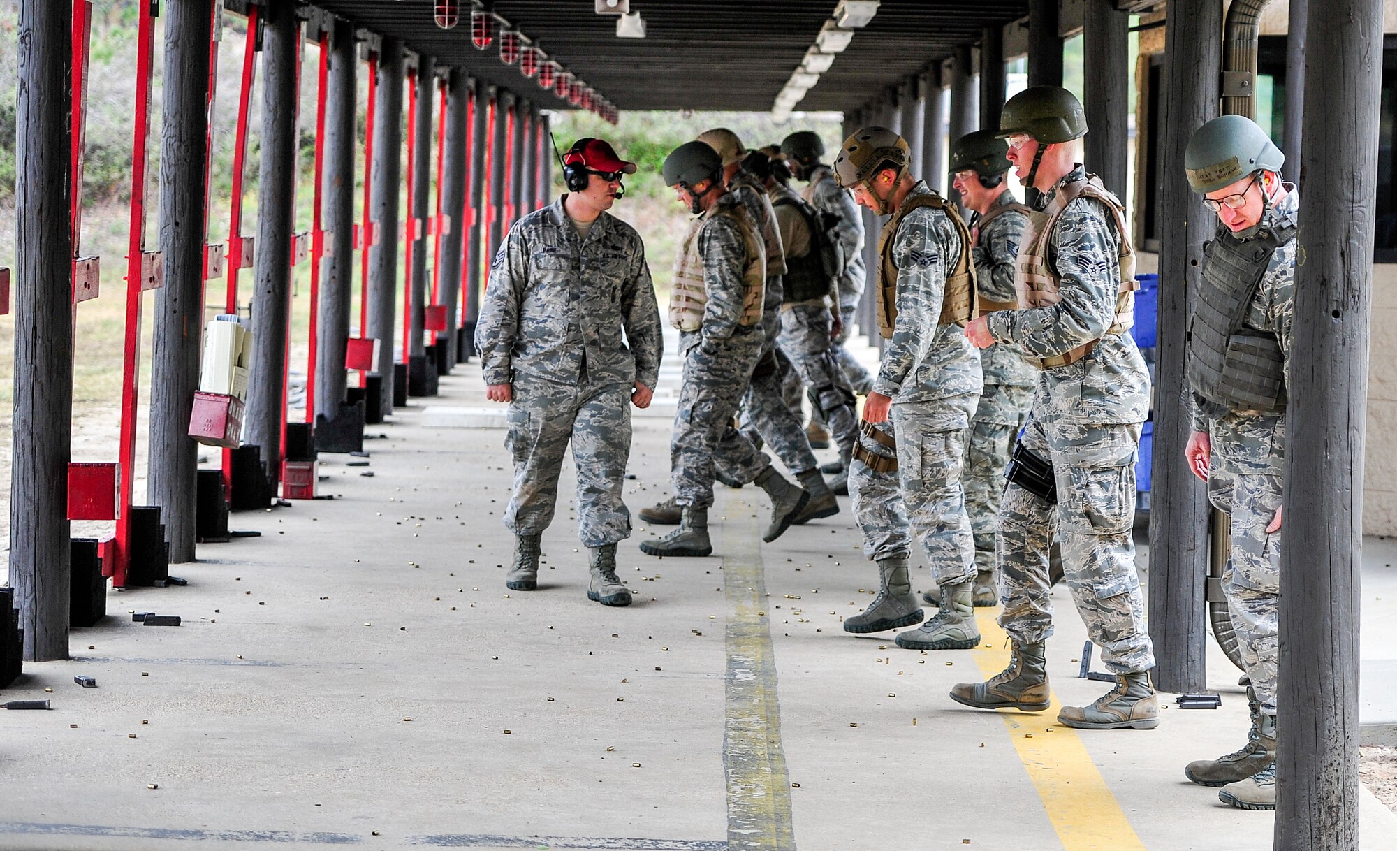Staff Sgt. Casey Paine, 1st Special Operations Security Forces Squadron Combat Arms Training and Maintenance instructor, provides instruction during small arms training at the firing range on Hurlburt Field, Fla., Nov. 13, 2014. Hurlburt’s CATM range is the second busiest in the Air Force; they qualify approximately 6,000 students on the M9 pistol and 5,000 on the M4 rifle, annually. (U.S. Air Force photo/Airman 1st Class Jeff Parkinson)
