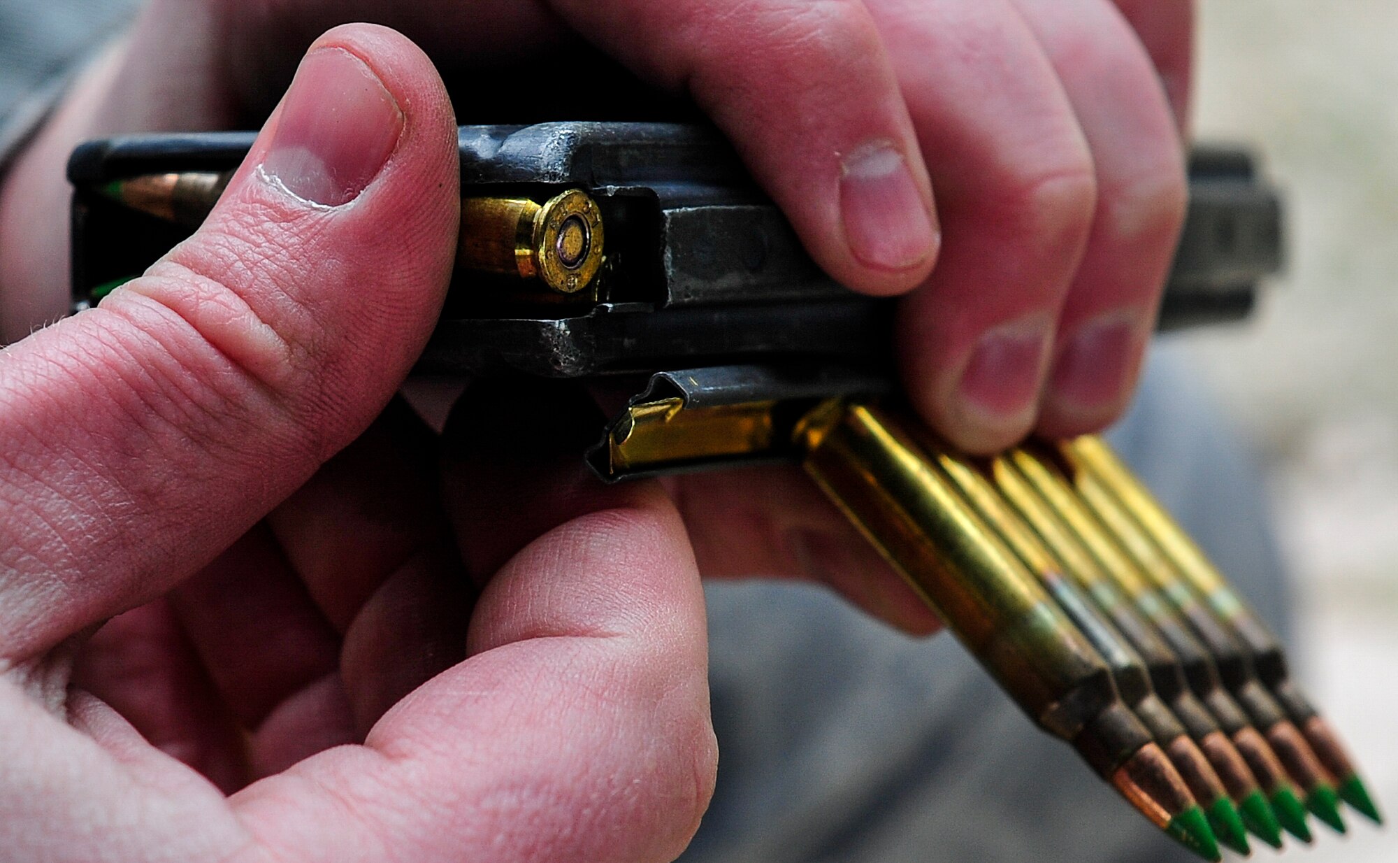 Senior Airman Christopher Rex, 1st Special Operations Contracting Squadron contract specialist, loads a M4 rifle magazine during small arms training at Hurlburt Field, Fla., Nov. 13, 2014. Combat Arms Training and Maintenance instructors train and qualify Airmen on required weapons needed for deployments. (U.S. Air Force photo/Airman 1st Class Jeff Parkinson)