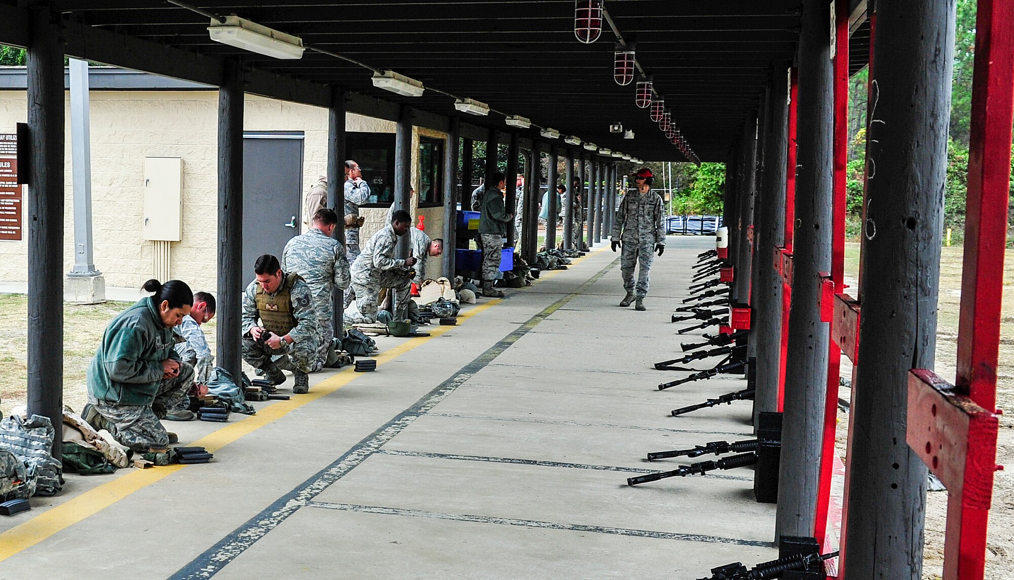 Airmen load their M4 rifle magazines during small arms training at Hurlburt Field, Fla., Nov. 13, 2014. Combat Arms Training and Maintenance instructors train and qualify Airmen on required weapons needed for deployments. (U.S. Air Force photo/Airman 1st Class Jeff Parkinson)